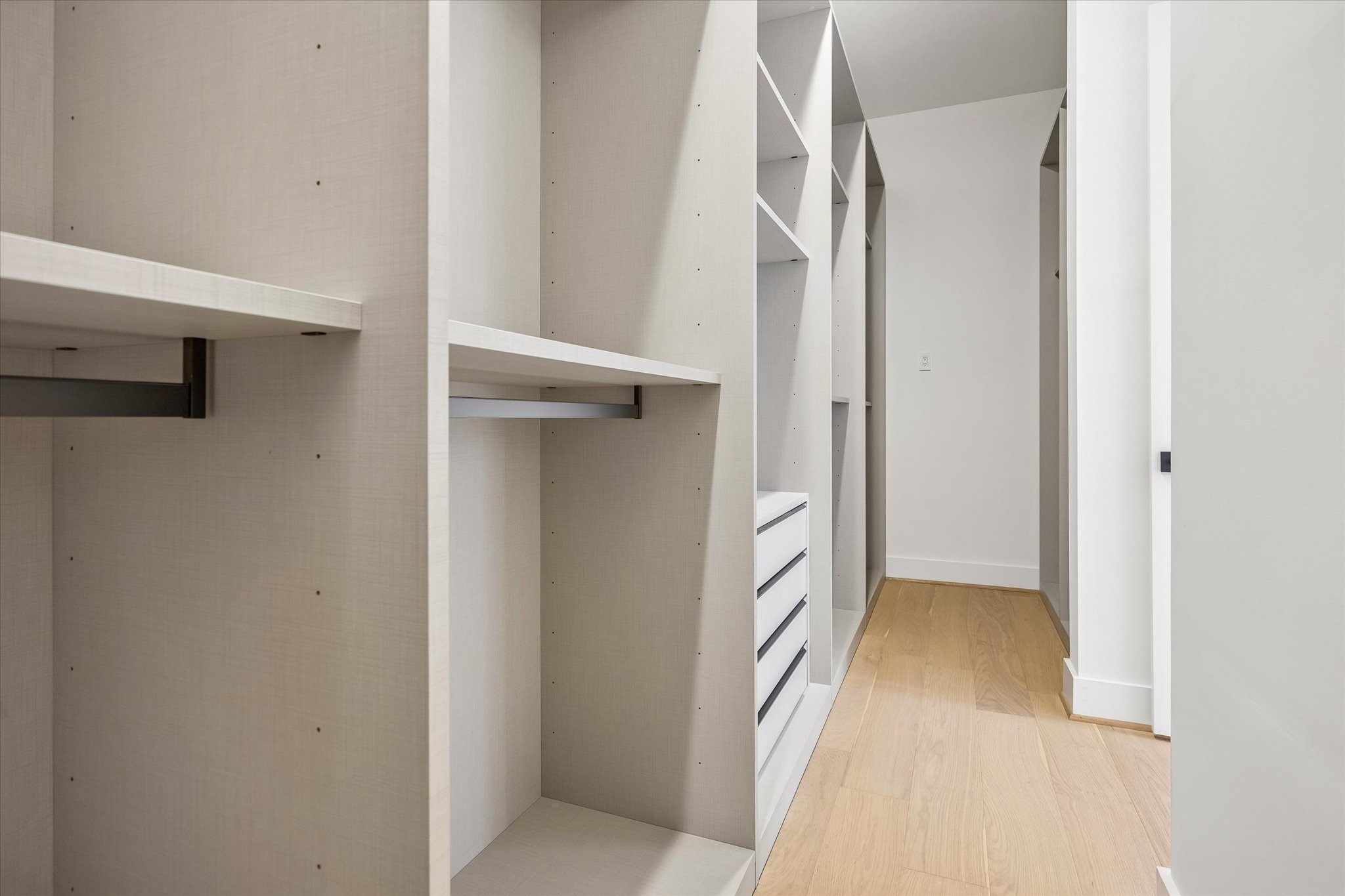 HUGE primary walk-in closet conveniently located off the second-floor hallway! Features extensive built-in hanging space, shelving & dresser drawers for fabulous organization and storage.