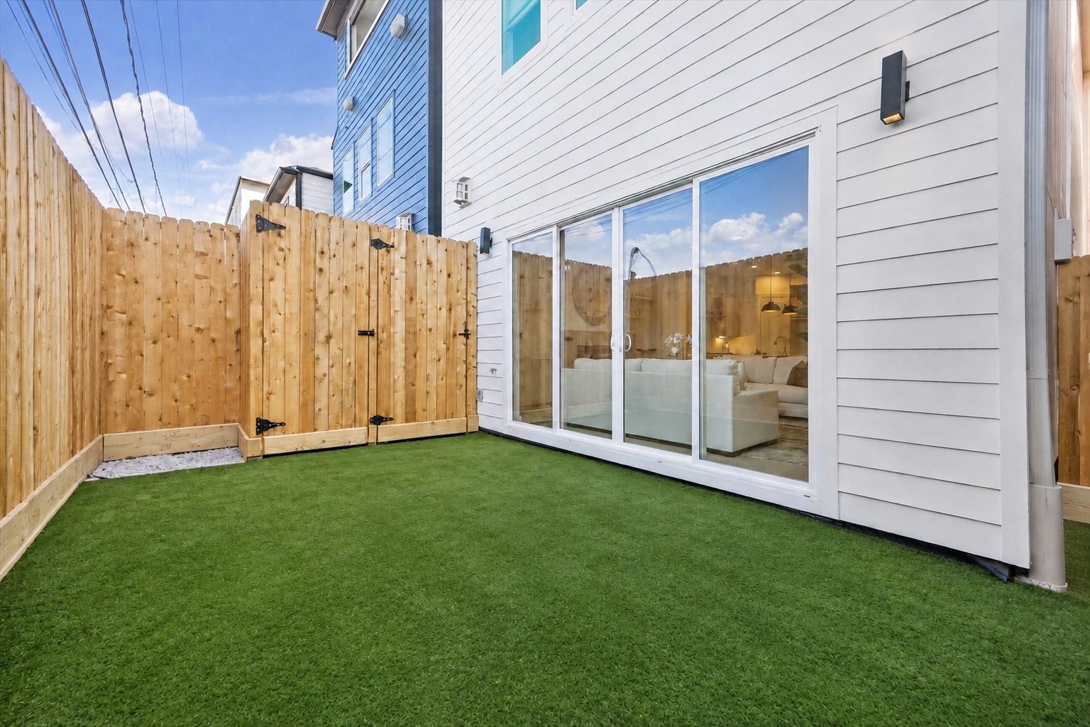 Private, fully fenced backyard features low-maintenance artificial turf & convenient access through expansive sliding glass doors from the family room. Wonderful outdoor space for lounging, grilling, entertaining or pets to play! Enjoy the ease of low-maintenance living in the heart of the desirable River Oaks Shopping Center Area.
