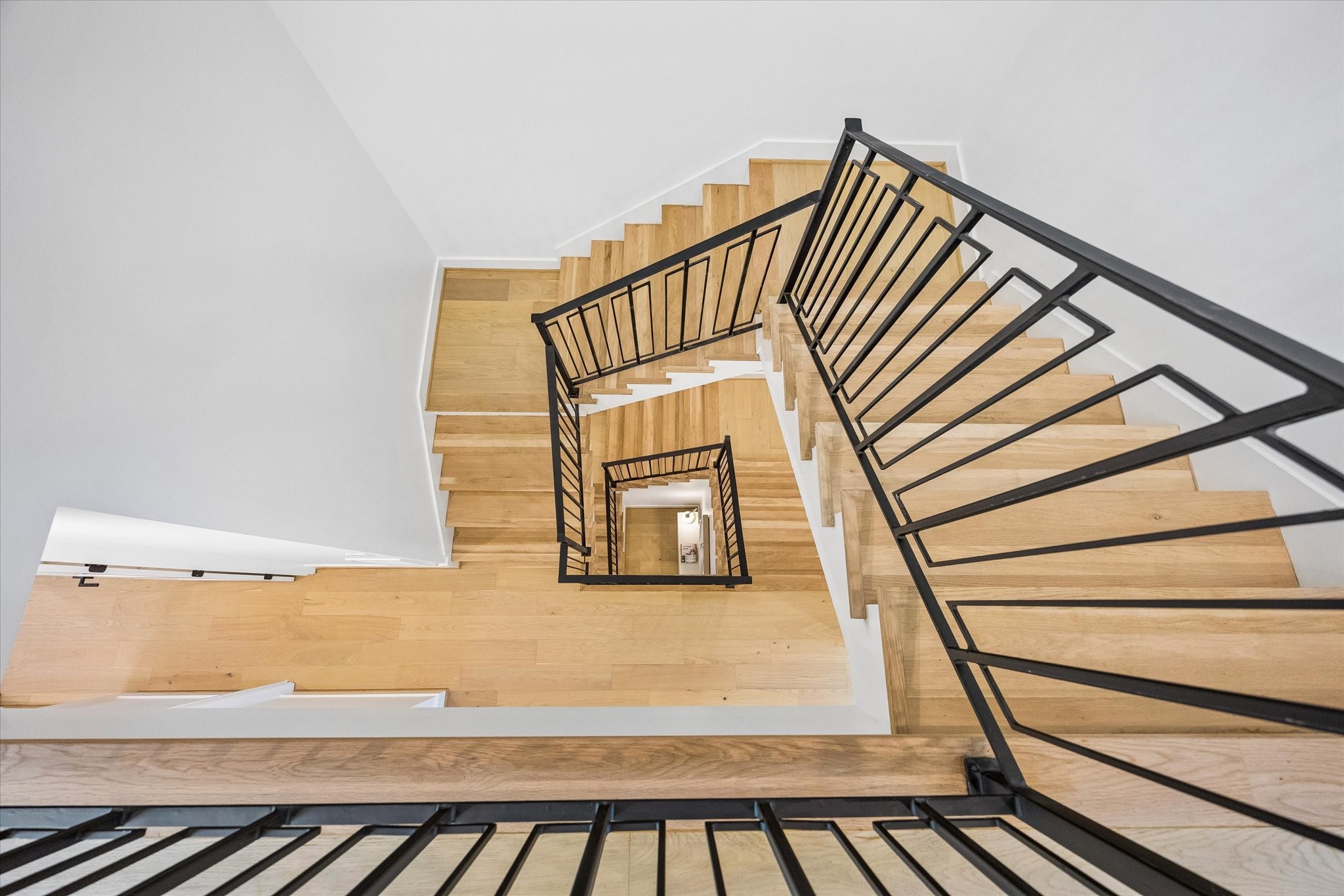 View at the top of the staircase on the 3rdfloor looking down. Sleek finishes throughout this stunning new construction!