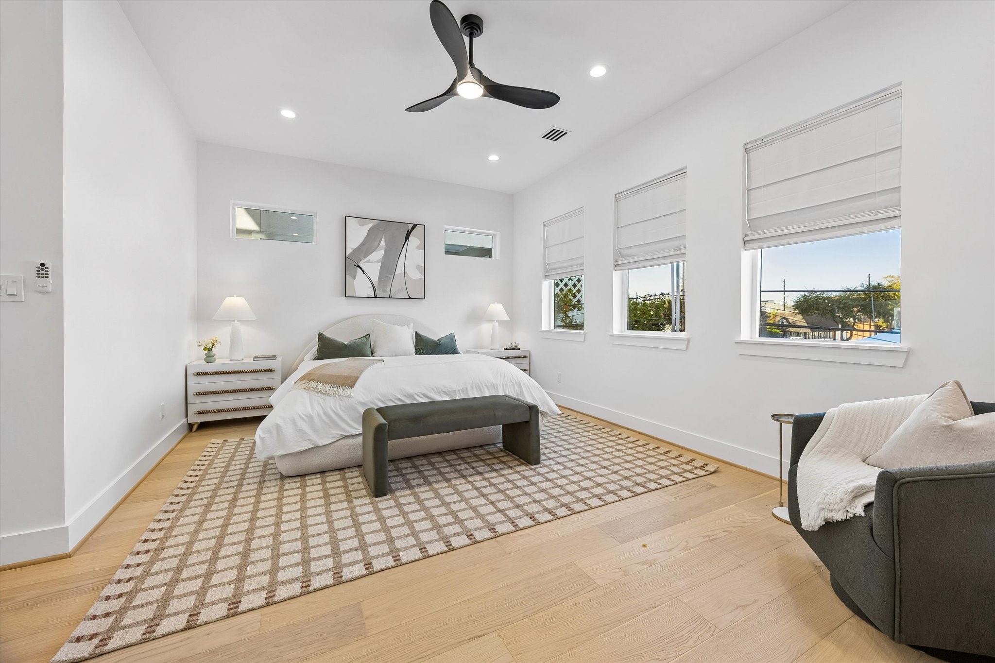 Spacious second-floor primary suite features soaring 10' ceilings, beautiful engineered wood flooring, recessed lighting & modern ceiling fan. Three large windows plus two additional high privacy windows provide abundant natural light. Wonderful room proportions allow for large furnishings and a comfortable private retreat.