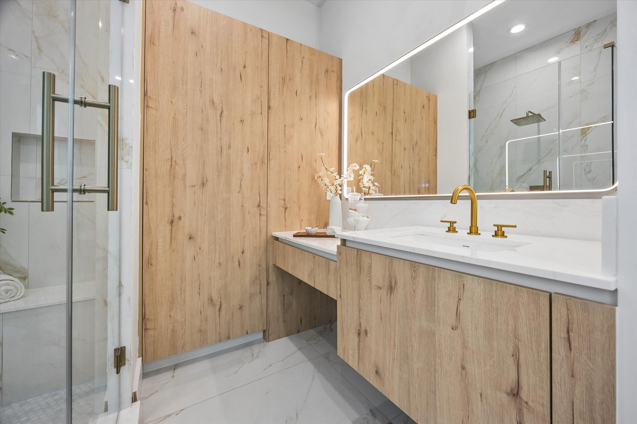 A closer up view of one of the separate vanities in the primary bath showing the vanity knee-space.