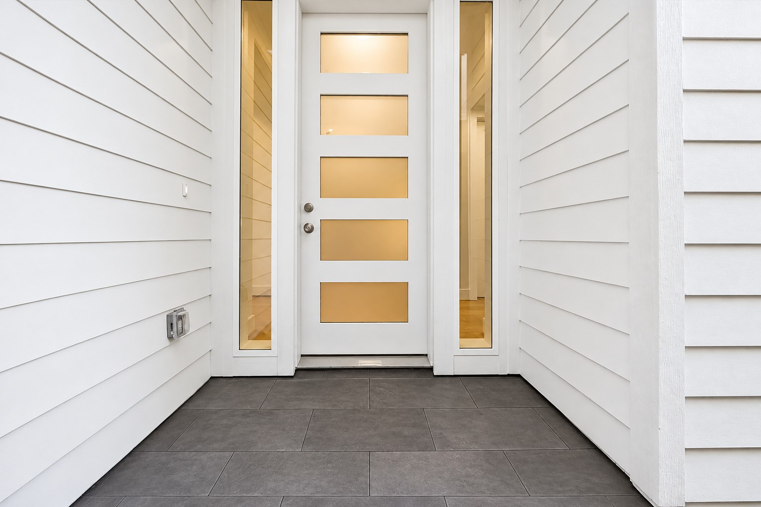 Welcoming side private entry features a gravel walkway w/ pavers (not shown) leading to the front door. Beautiful  exterior hardie siding (no stucco!), low-maintenance landscaping & private driveway make this home ideal for effortless everyday living!