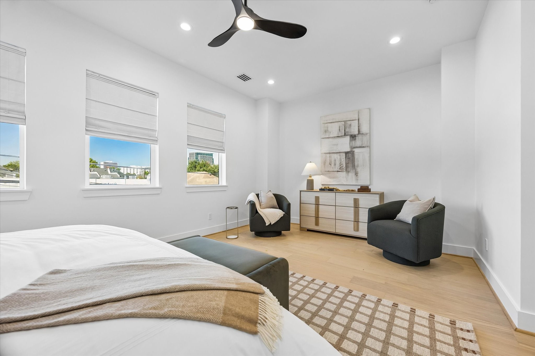 Another view of the beautiful primary suite highlighting the spacious layout, tall ceilings & abundant natural light. Conveniently located on the second floor near the utility room. An oversized walk-in closet with built-ins & luxurious en-suite bath complete this fabulous primary retreat!