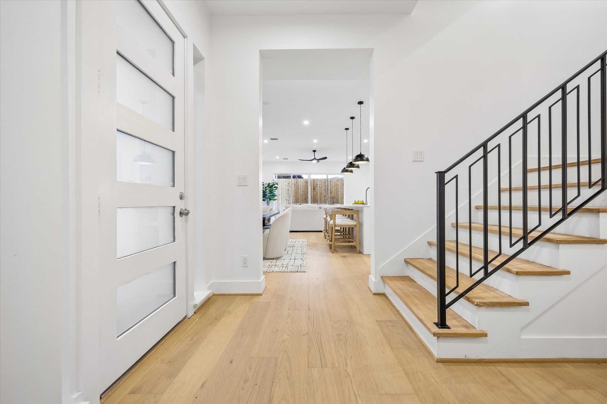 Step inside to a welcoming entry featuring beautiful engineered wood floors, recessed lighting & a staircase w/ decorative black metal railing. Notice the elevator-capable walk-in closet, offering the potential for future elevator installation connecting all 3 floors! Convenient powder bath located just off the entry. Straight ahead leads to the kitchen/living/dining areas.