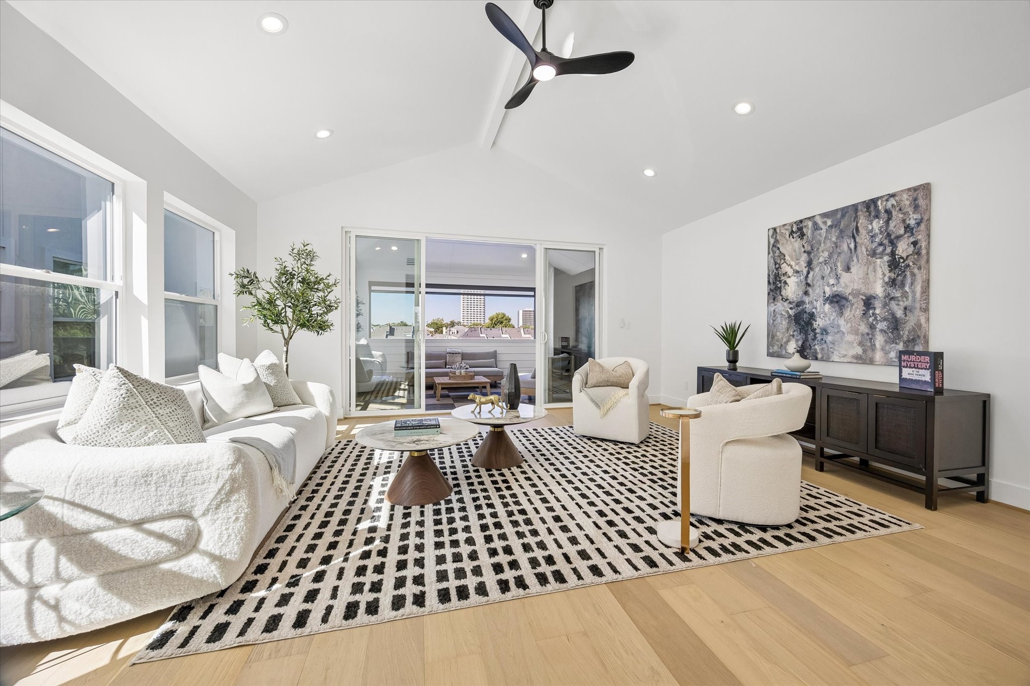 Fabulous third-floor gameroom/flex room features soaring 12' vaulted ceiling w/ decorative beam, beautiful engineered wood flooring, recessed lighting & modern ceiling fan. Expansive sliding glass doors open directly to the covered terrace! Versatile space perfect for a home office, playroom, media room or additional living area.
