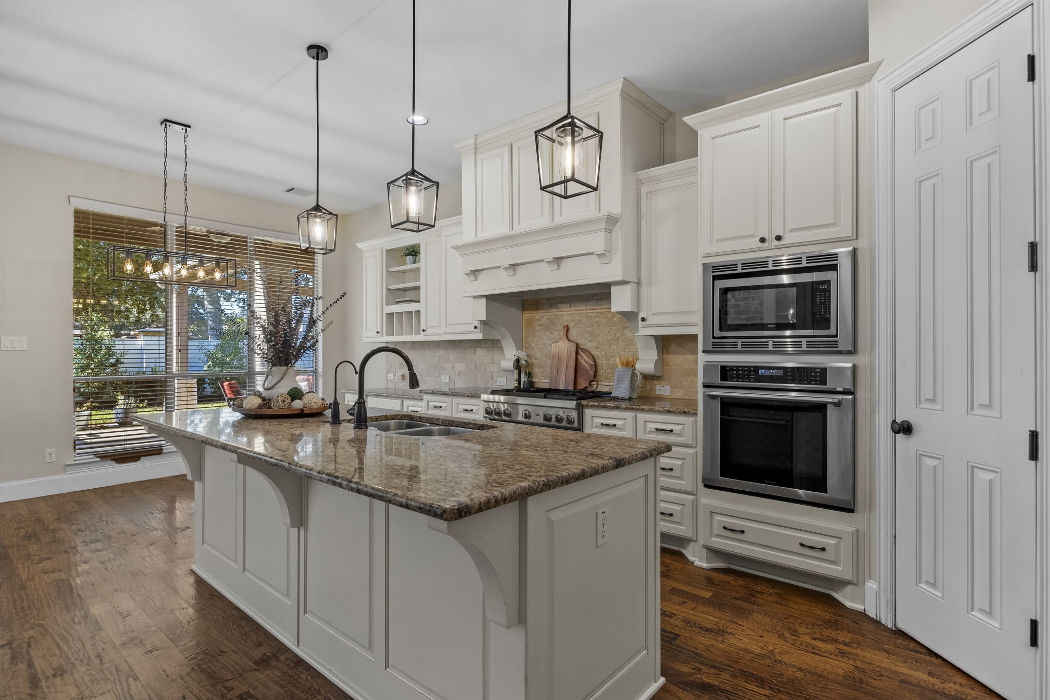 The kitchen is equipped with premium Thermador and KitchenAid appliances, offering exceptional quality and performance for the home chef. The oversized island provides generous prep space, while the open layout offers easy access to the breakfast area and backyard.