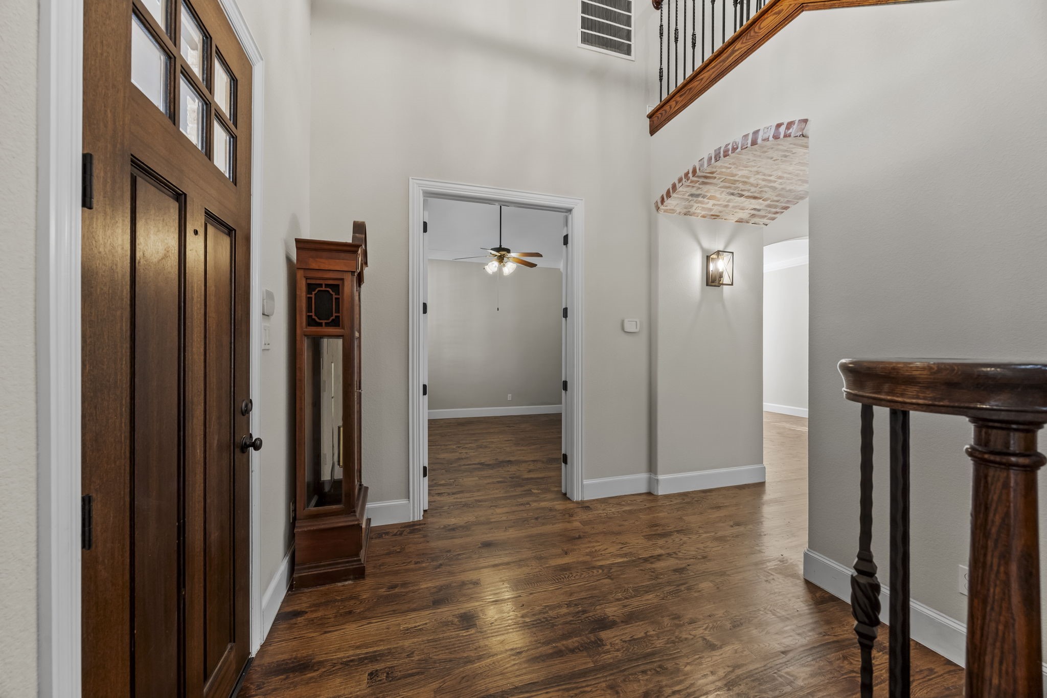 View of the foyer with a spacious home office/flex room on the left through the double french doors.