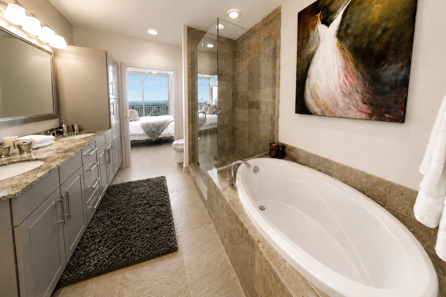 Spacious primary bath with a view! Featuring dual vanities, granite countertops, a soaking tub and separate glass-enclosed shower for a refined, spa-inspired retreat.