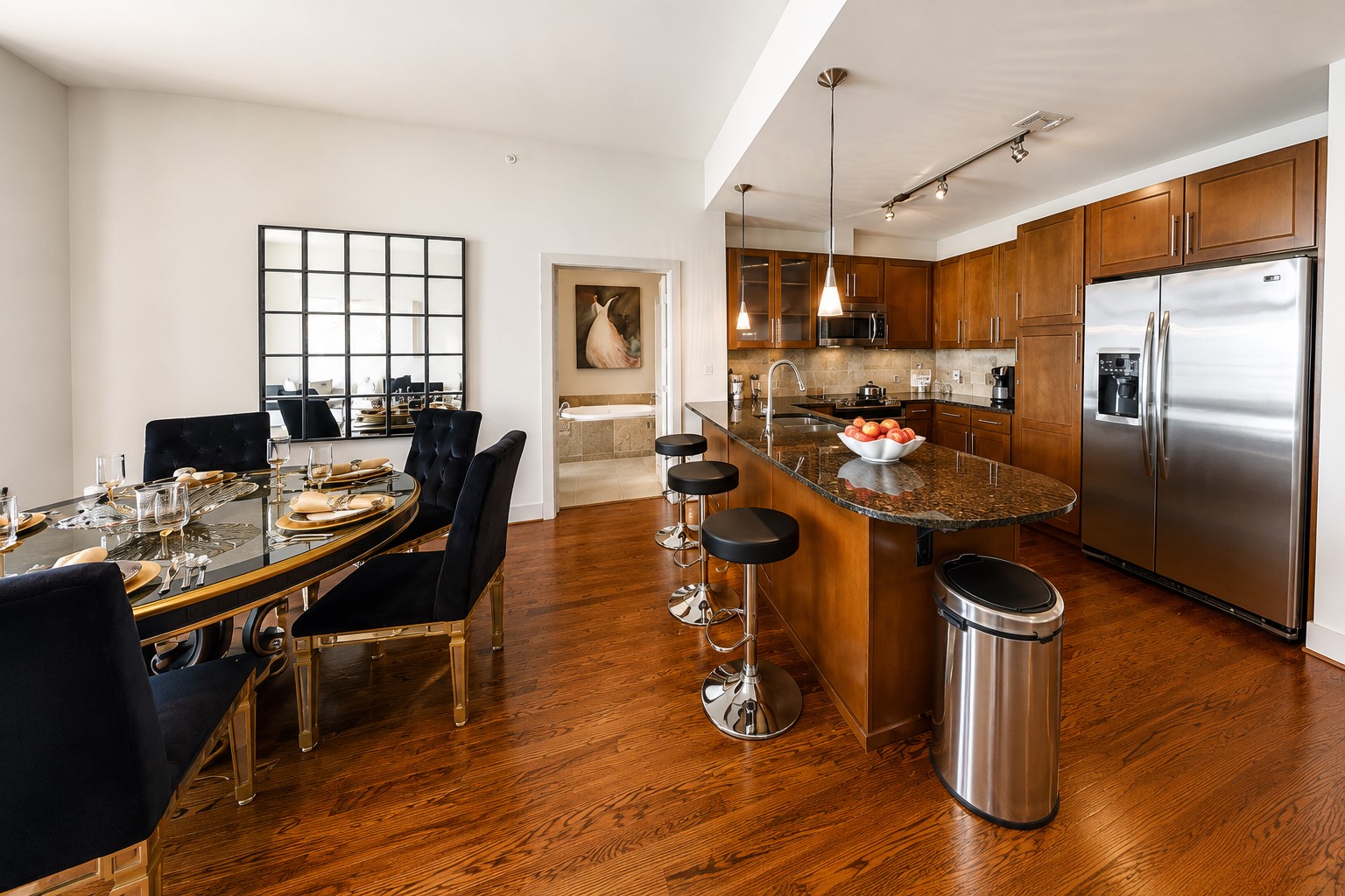 Gourmet kitchen offers a dining island, granite countertops, stainless steel appliances, abundant cabinetry and generous counter space, opening effortlessly to the dining and living areas.