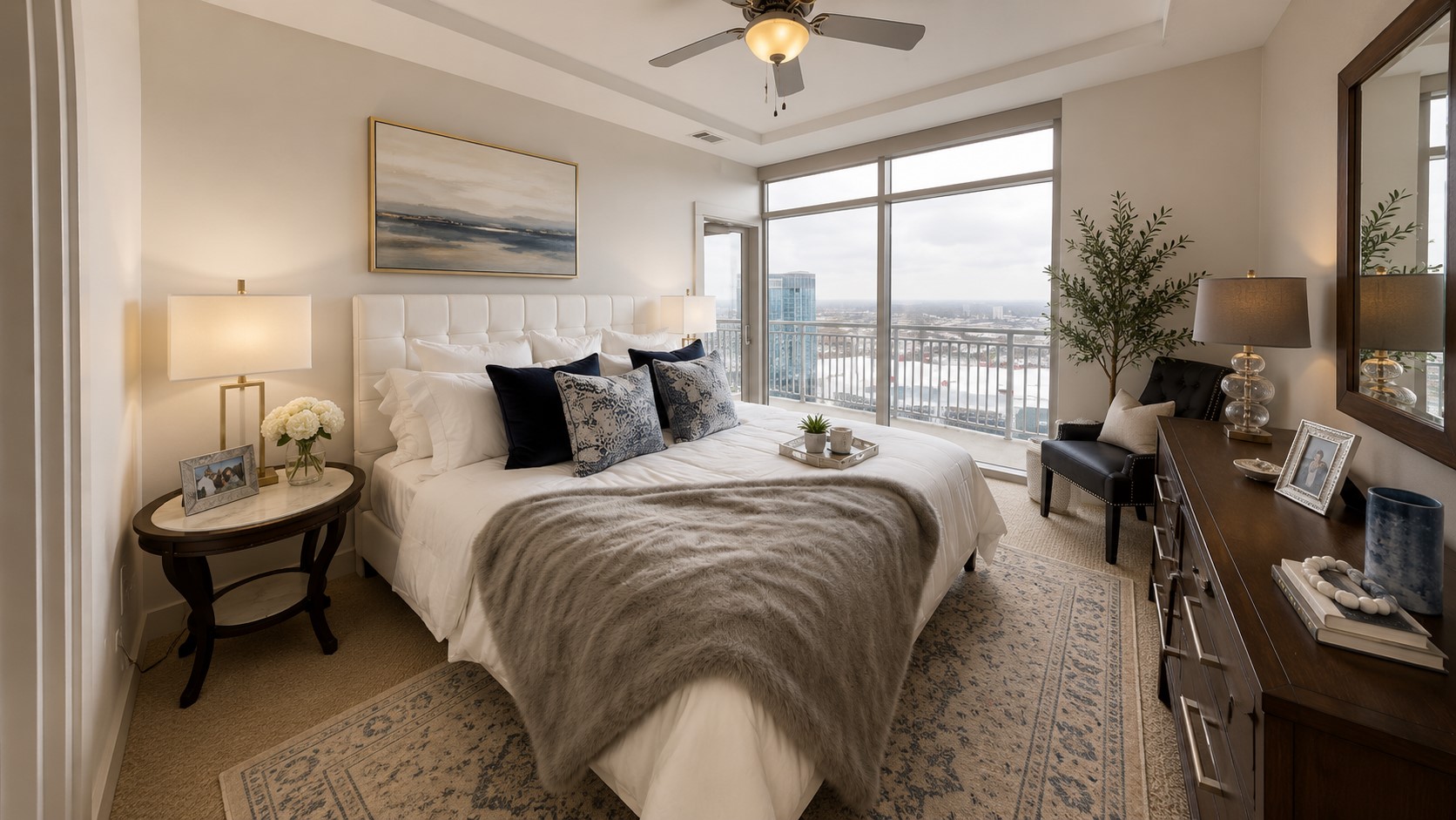 Serene primary bedroom features floor-to-ceiling windows, balcony access and sweeping views from this exceptional high-rise setting.