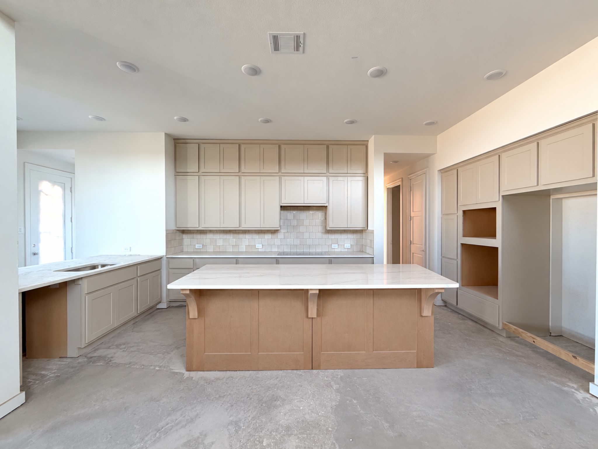 Designer U shaped kitchen allows for an oversized island with abundant cabinetry