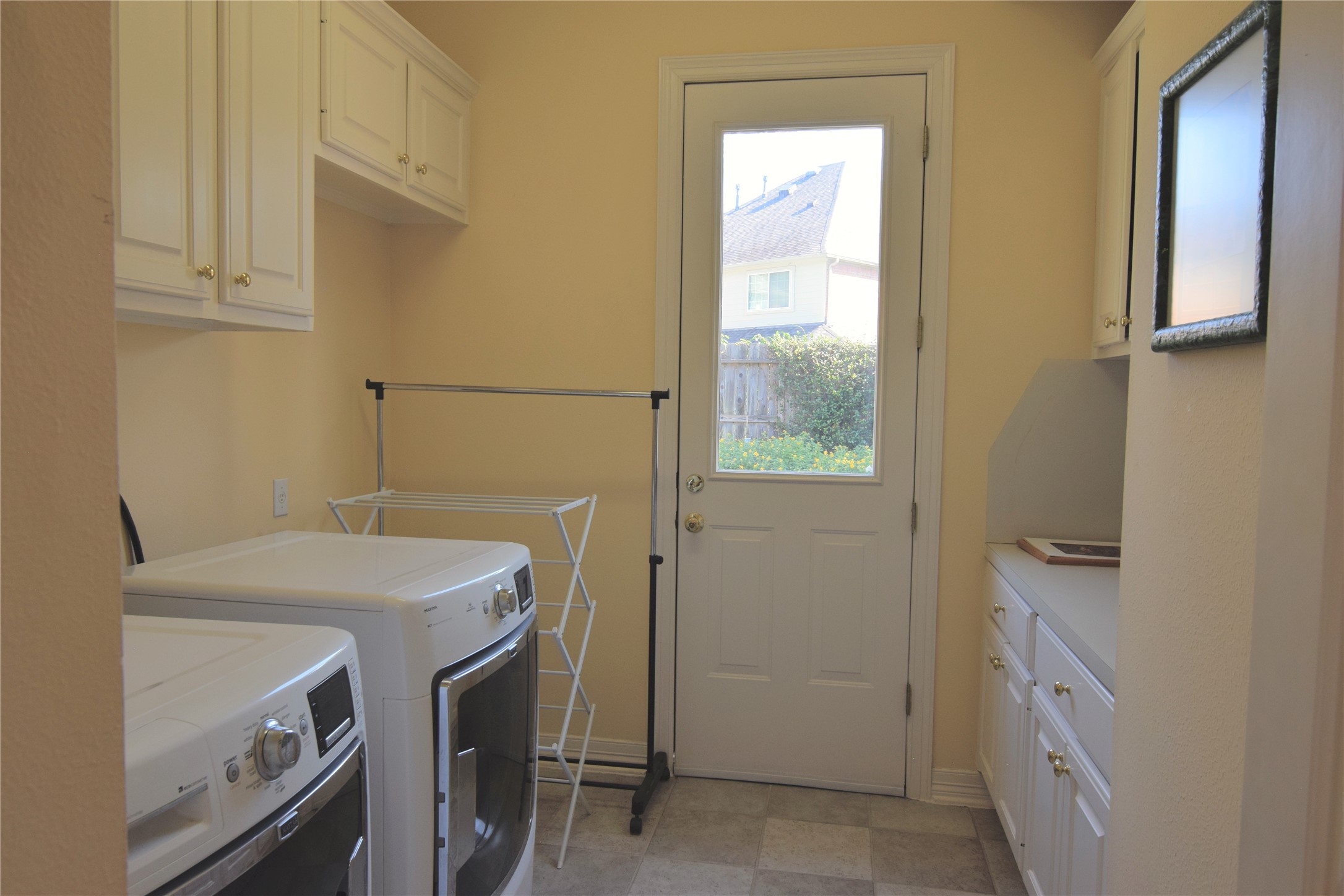 Laundry with Cabinet Storage and Folding Counter