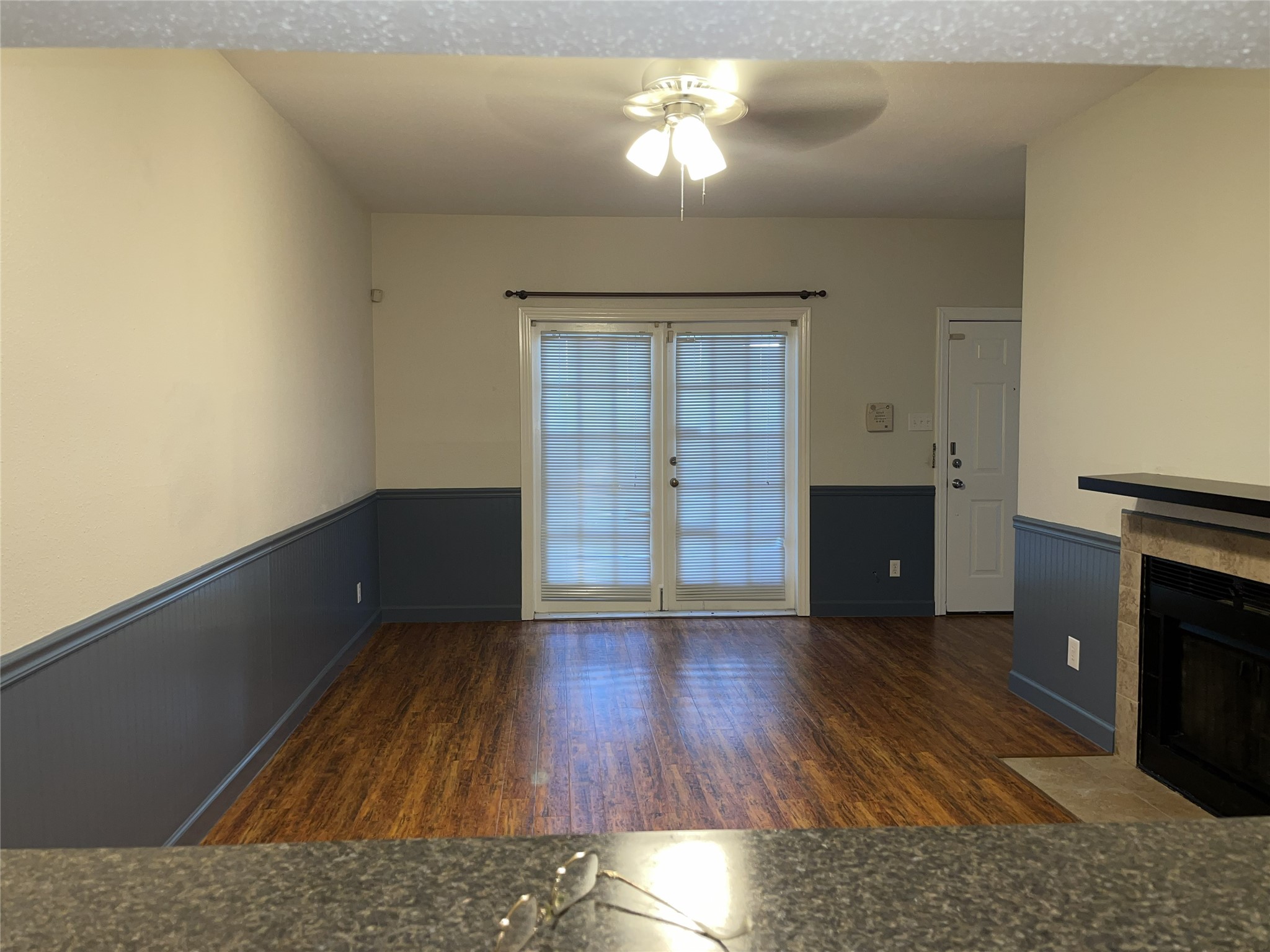 The living room offers a view of the French doors, highlighting the room's layout and providing a blank canvas for your own furnishings and personal style.