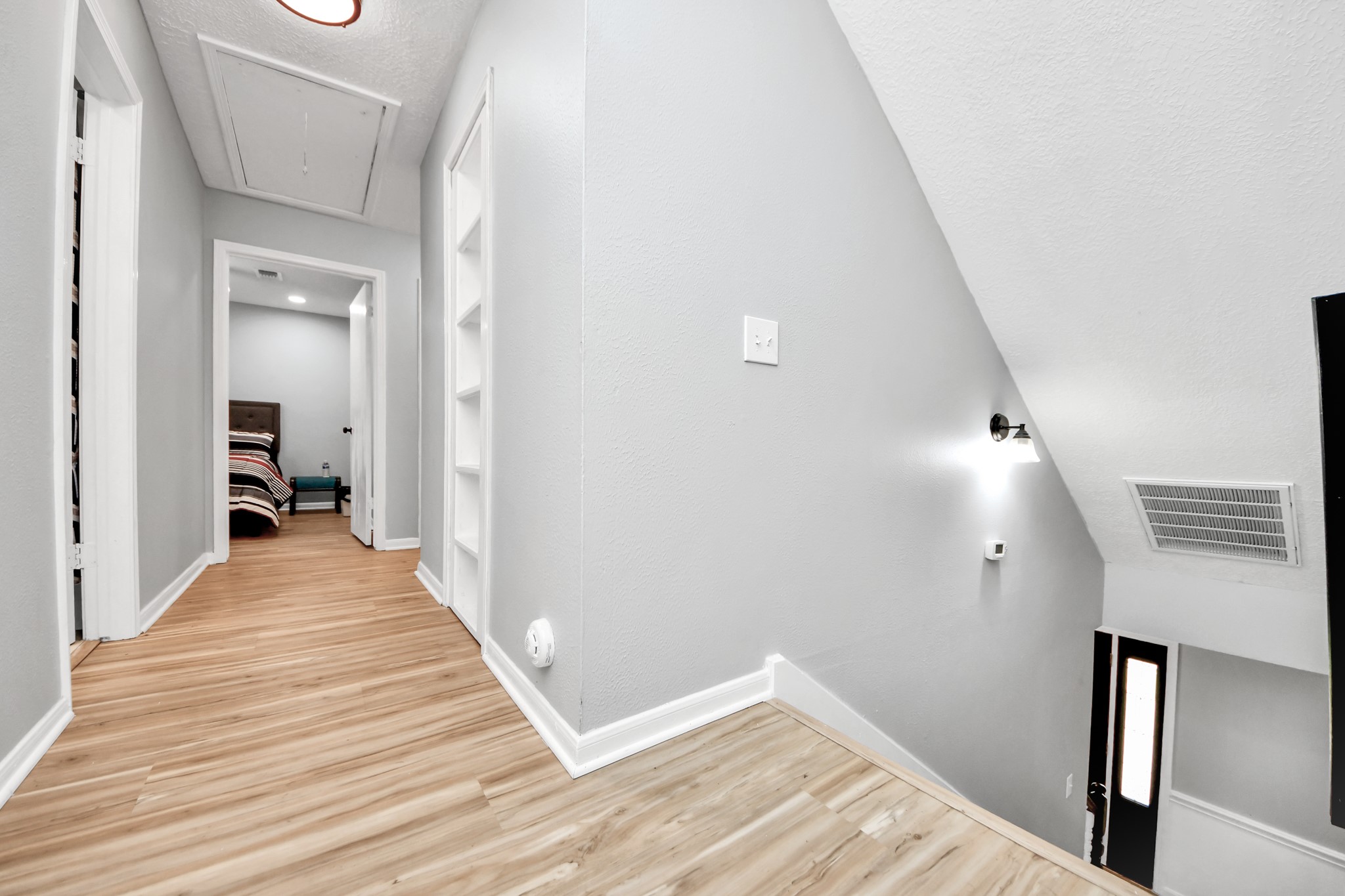 The central junction of the quiet quarters. This second-story landing branches off seamlessly into the independent sleeping sanctuaries and secondary baths.