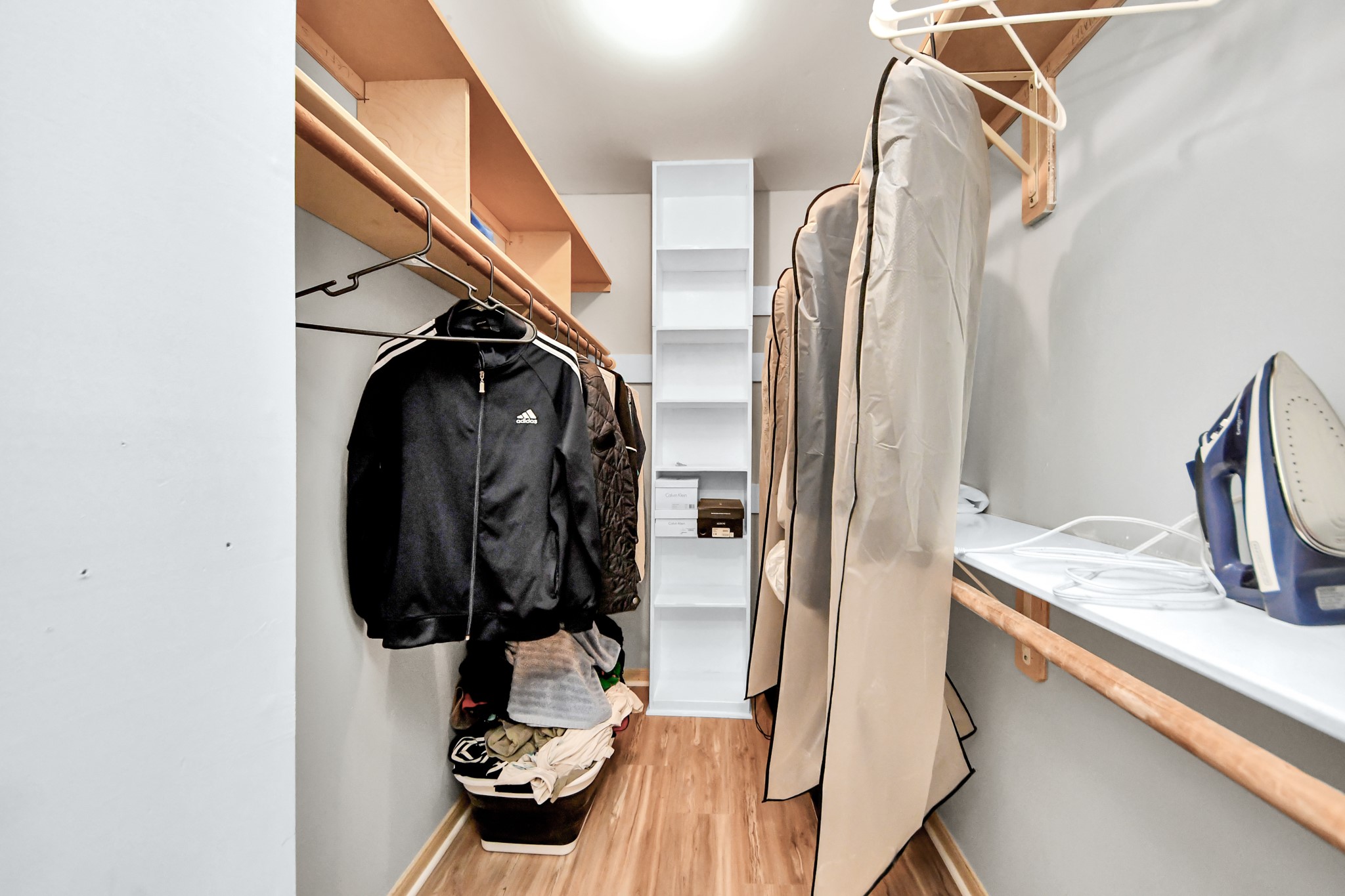 This full-entry closet features a comprehensive network of built-in shelving and integrated hanging rods to maximize storage efficiency.