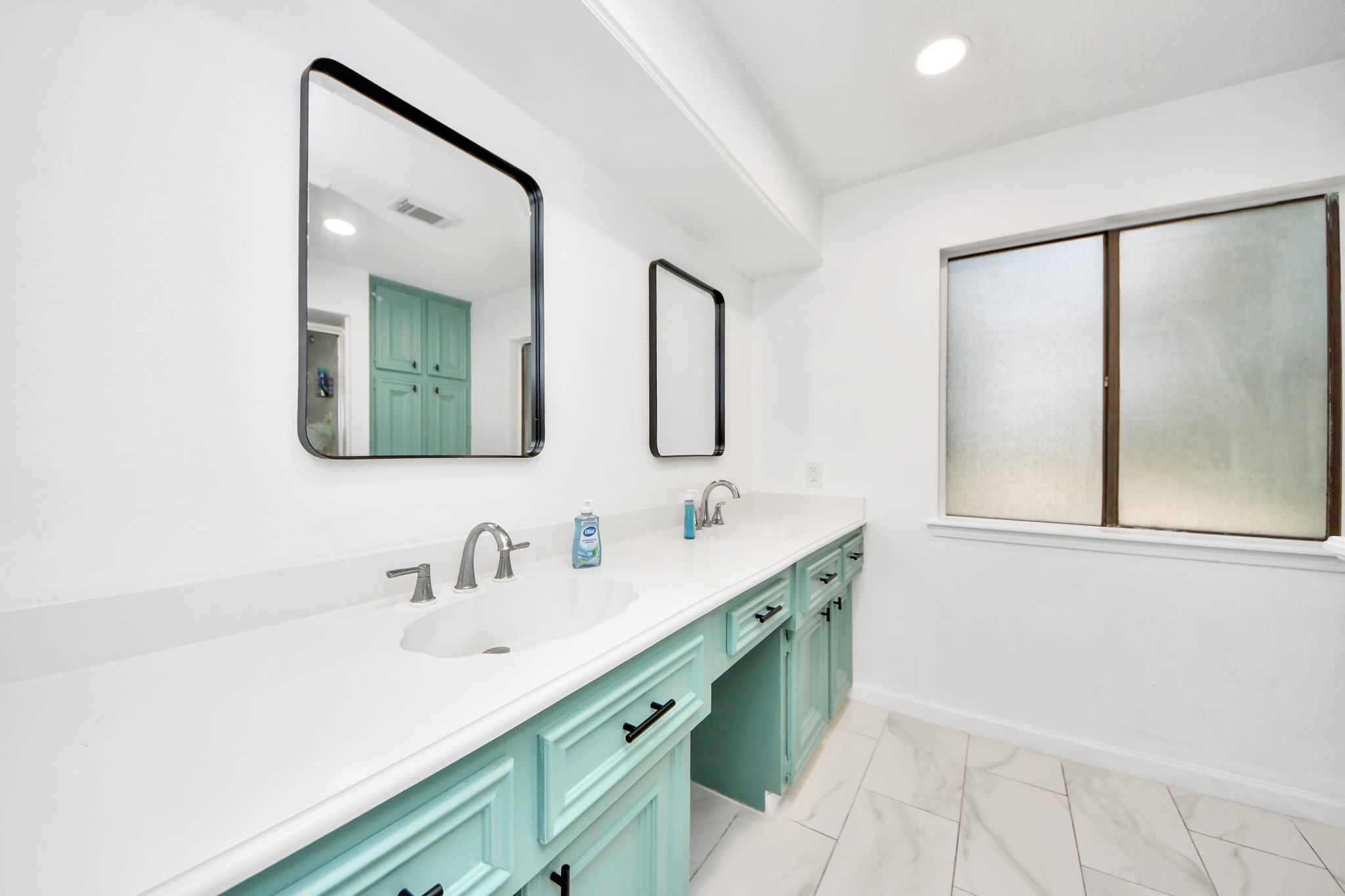 Daily routines, elevated. An expansive dual-sink vanity commands the primary bath, providing individual personal grooming areas alongside an exceptional amount of storage.