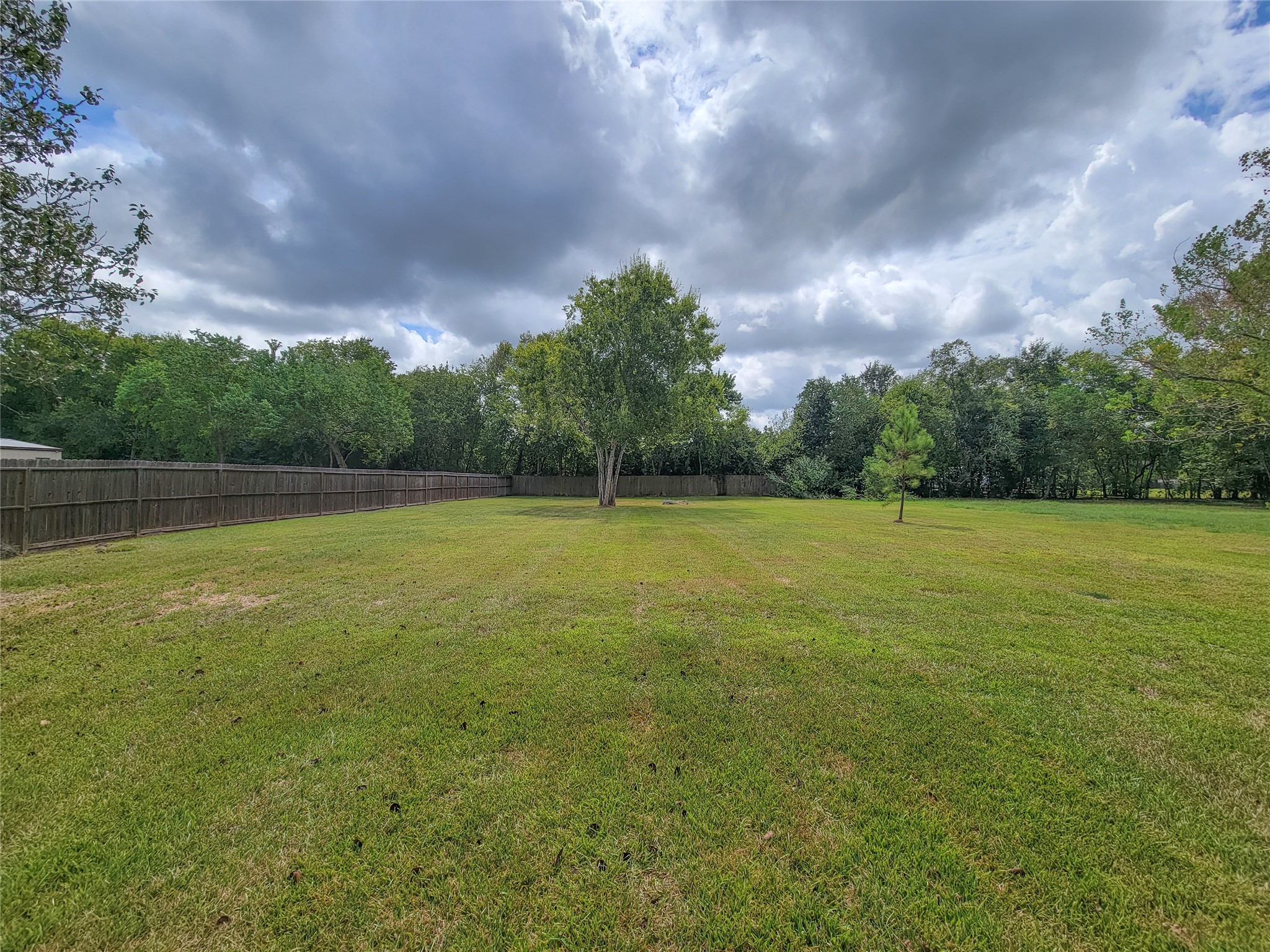 An expansive, well-manicured lawn surrounded by lush greenery offers both privacy and ample space for outdoor activities. An expansive, well-manicured lawn surrounded by lush greenery offers both privacy and ample space for outdoor activities.