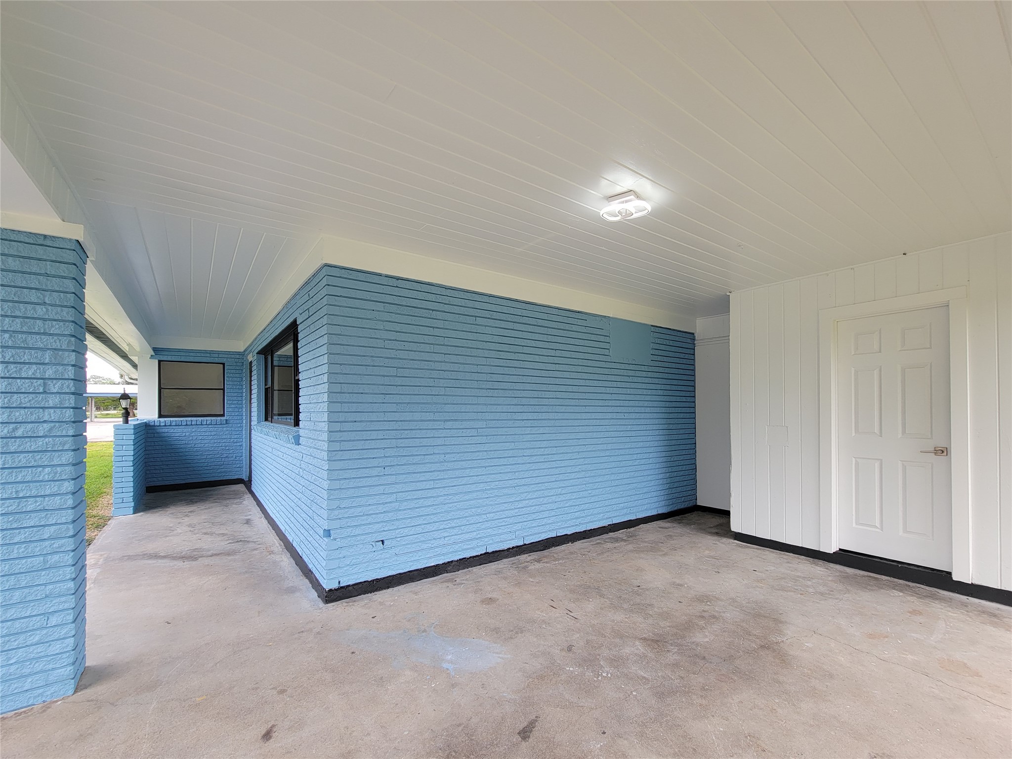 Experience outdoor relaxation and entertainment in this charming covered patio, featuring cozy blue brick accents. Experience outdoor relaxation and entertainment in this charming covered patio, featuring cozy blue brick accents.