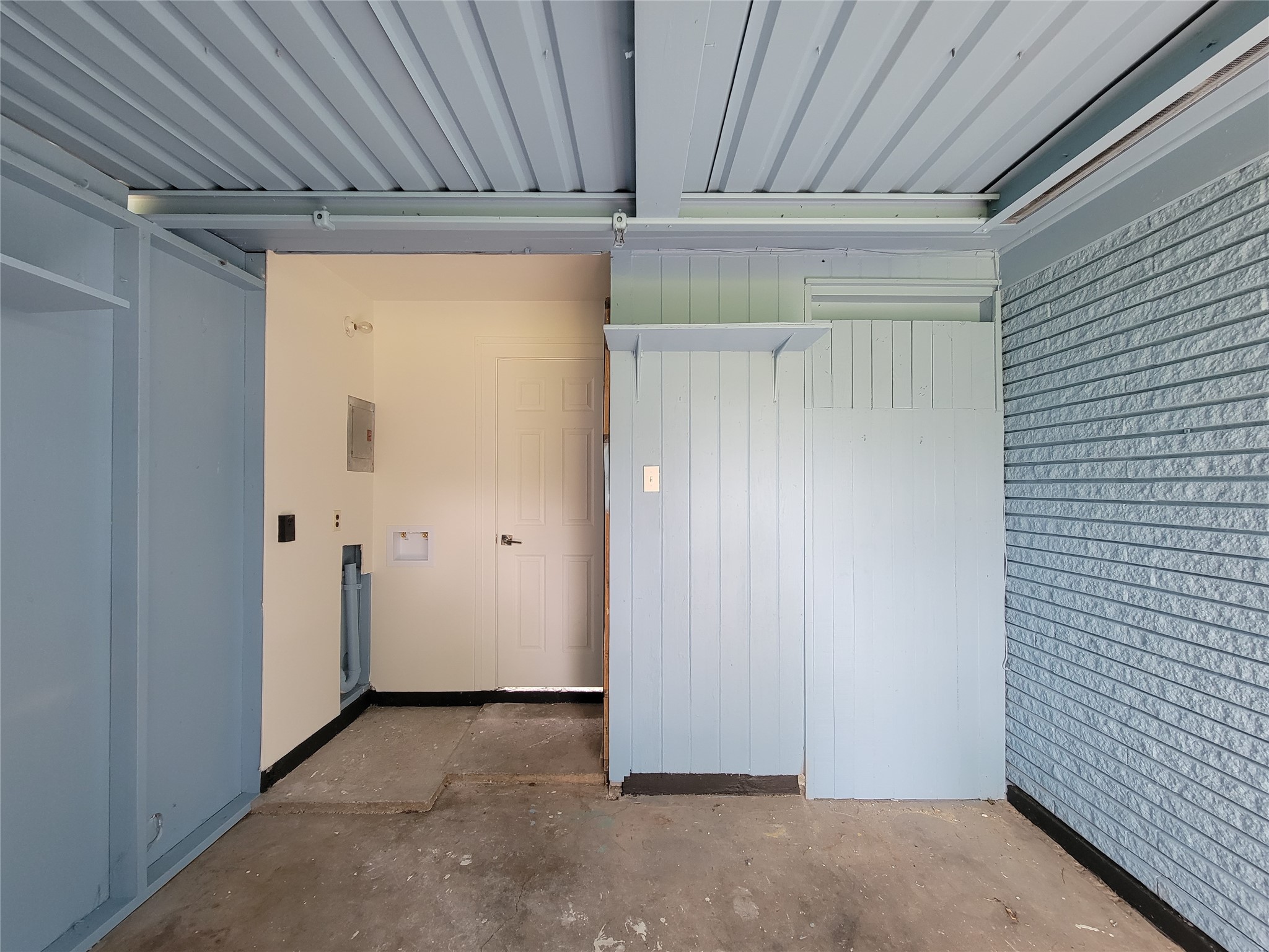 Expansive garage featuring durable flooring, abundant storage options, and seamless access to the main home for ultimate convenience.