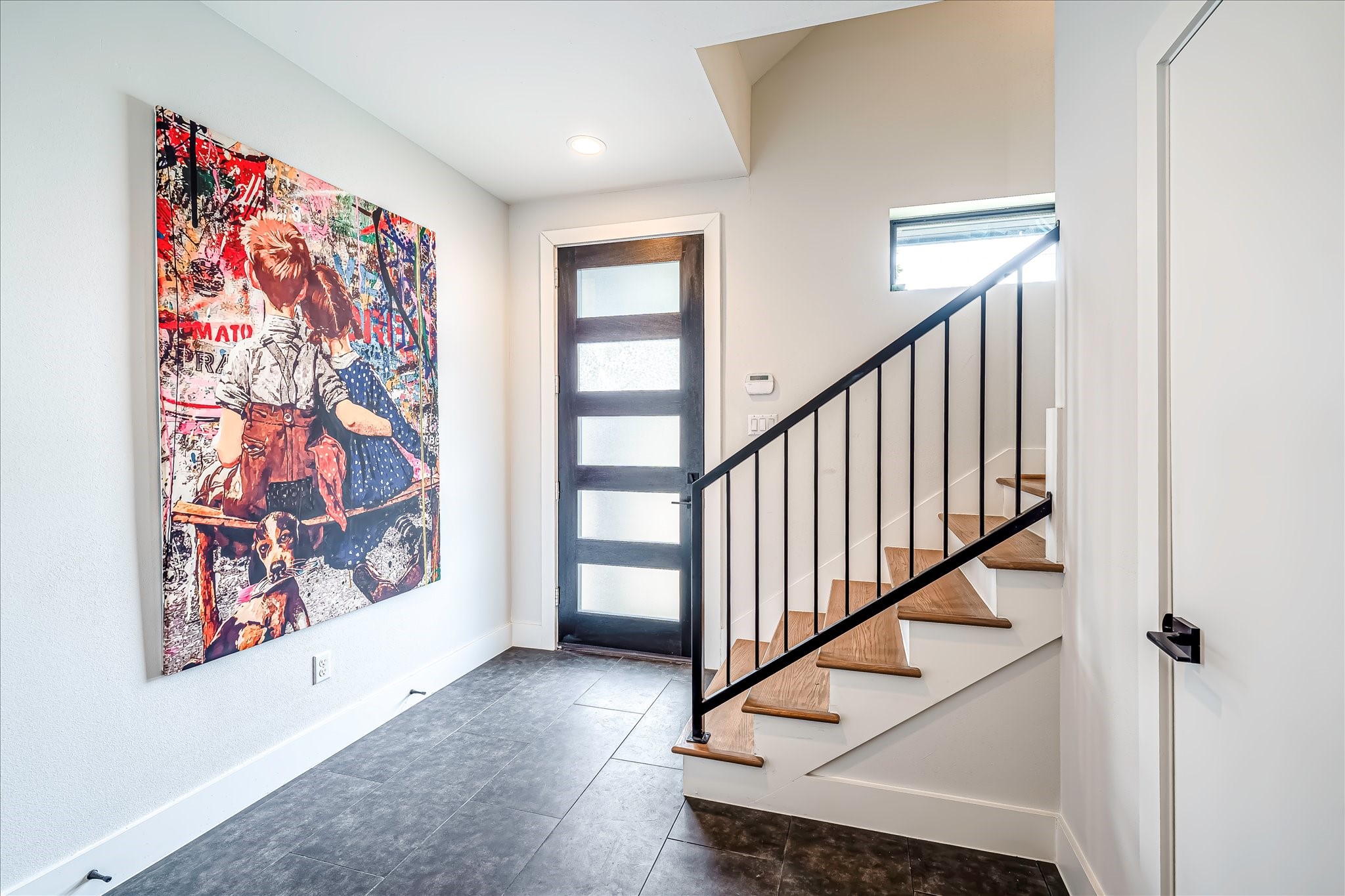 Welcoming entry featuring beautiful hand-scraped Red Oak hardwoods from 2nd floor up.