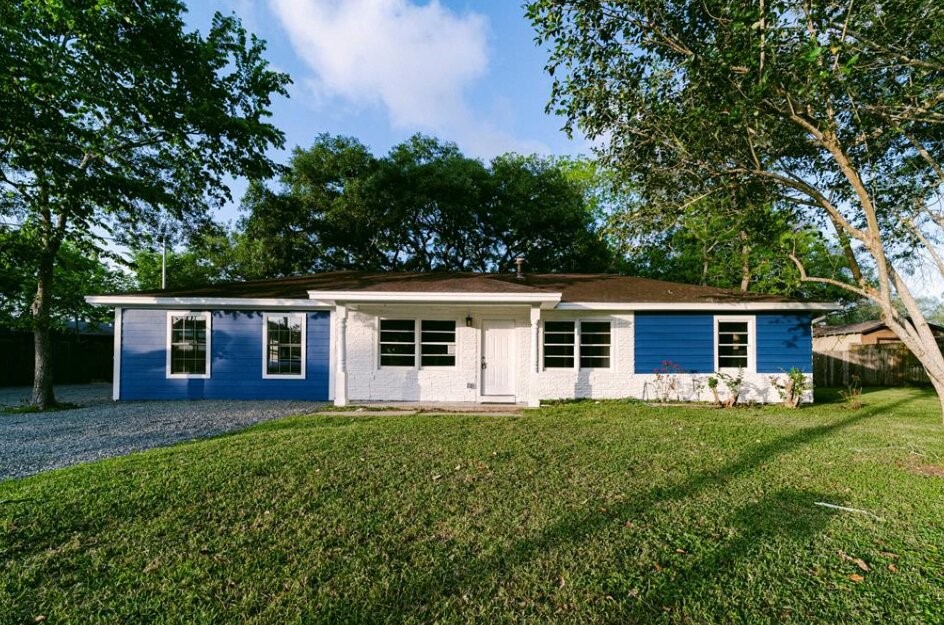 Charming single-story home with blue and white exterior and spacious yard. Charming single-story home with blue and white exterior and spacious yard.