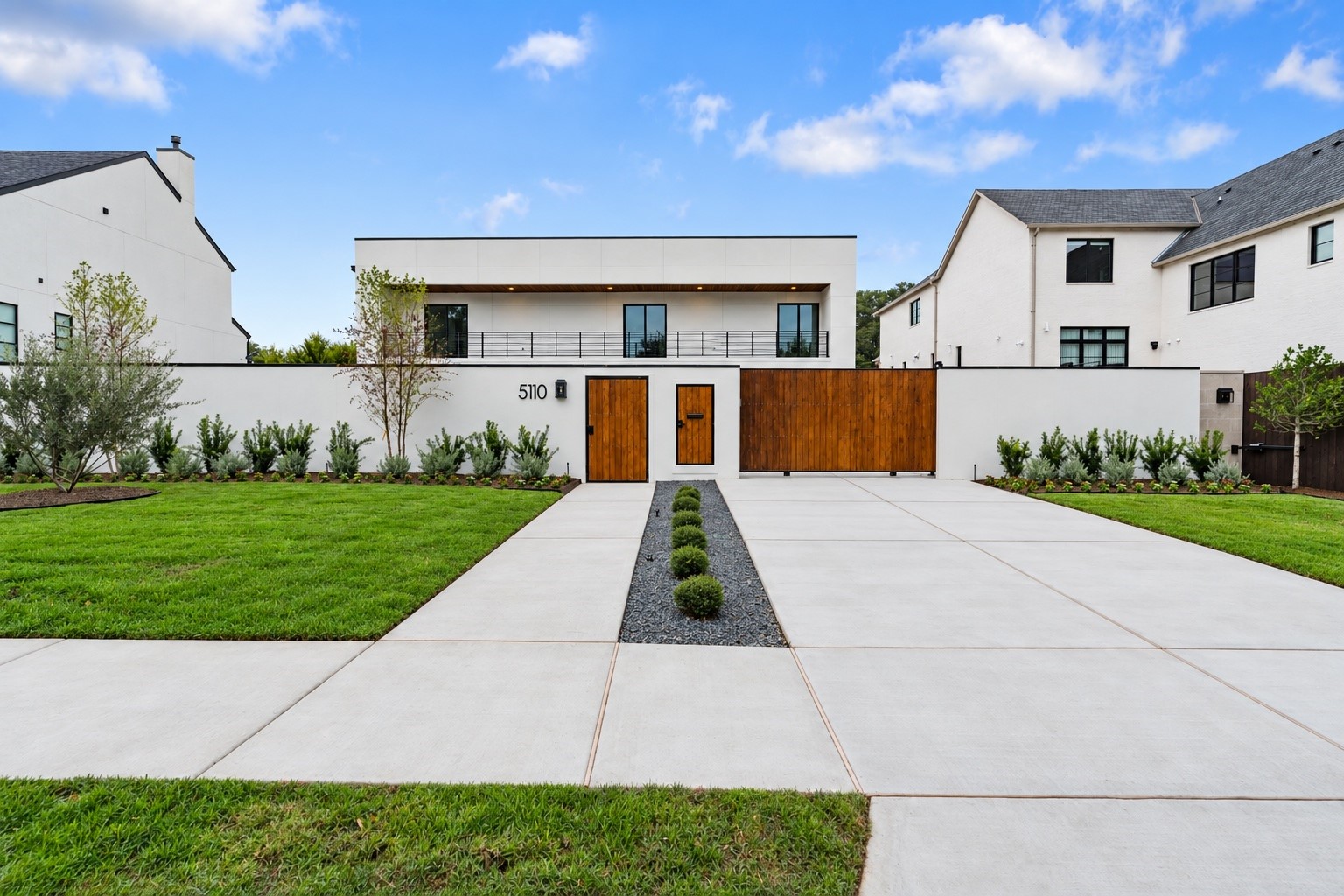 Sleek, sophisticated, and completely private, this modern stucco estate sits behind elegant walls and a gated entry, with a covered front balcony overlooking the approach. A discreet smart parcel gate receives every delivery securely while your sanctuary stays closed.