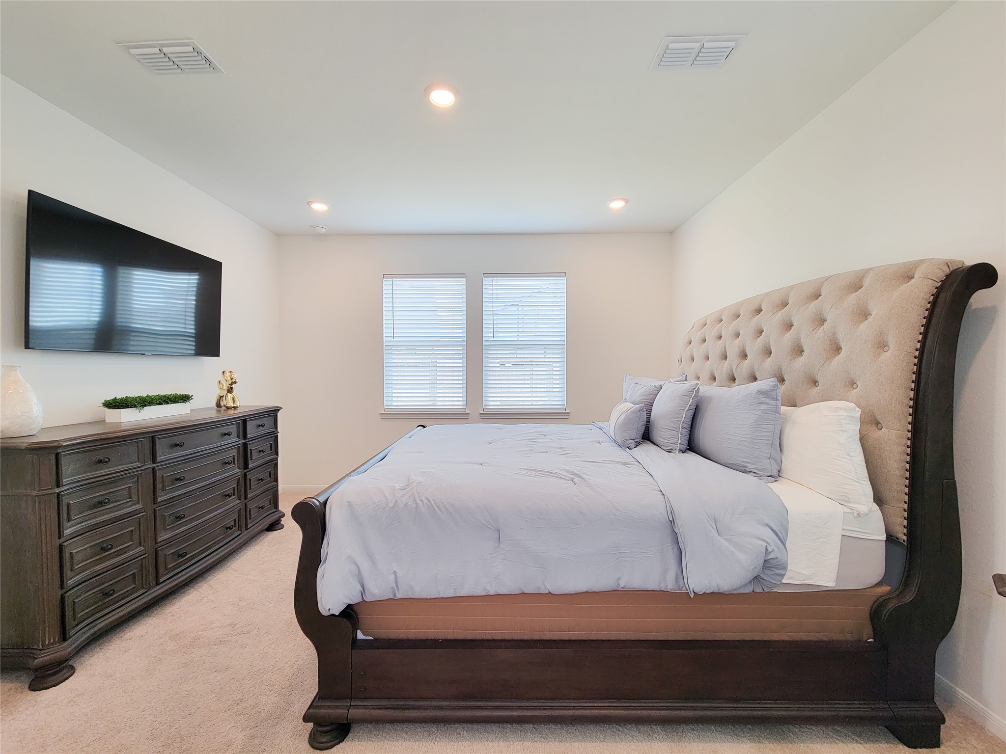 A spacious bedroom with neutral colors creates a serene atmosphere.