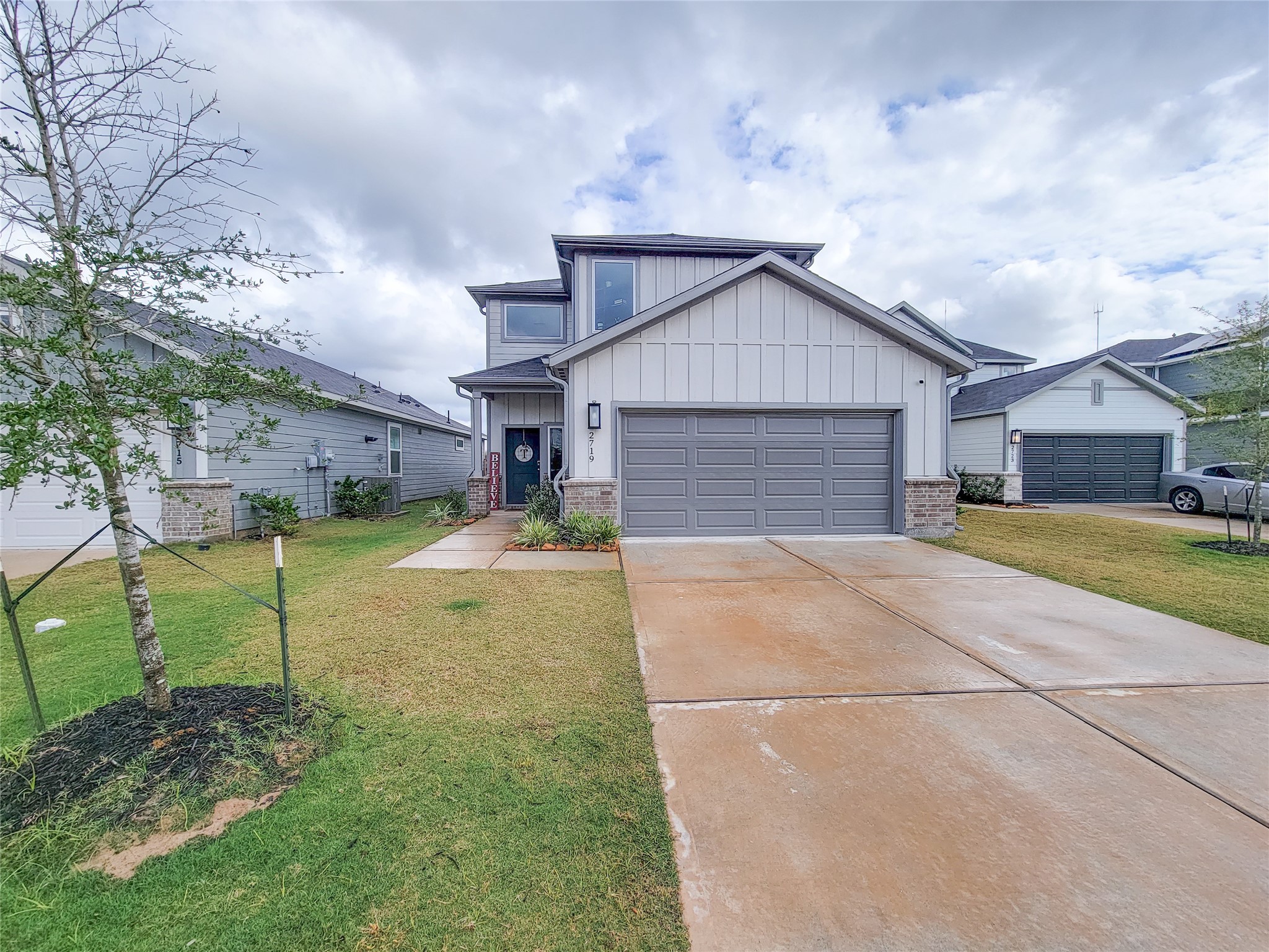 This modern two-story home features a clean exterior with a gabled roof, a spacious two-car garage, and a well-maintained front yard. Ideal for buyers seeking a contemporary design in a quiet neighborhood.