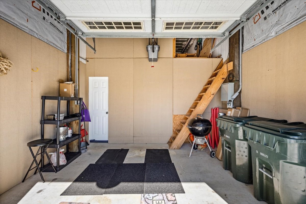 Garage has ladder steps to floored storage space