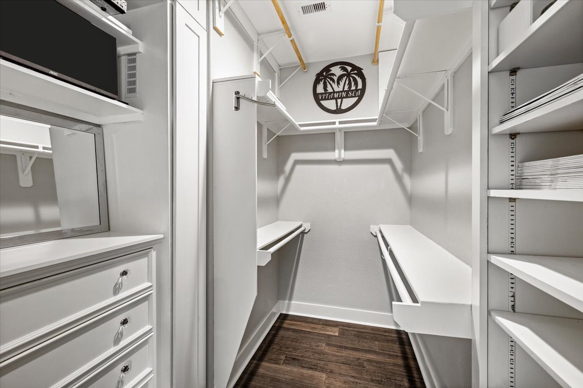 One of the walk-in closets in primary bedroom that has hidden security system