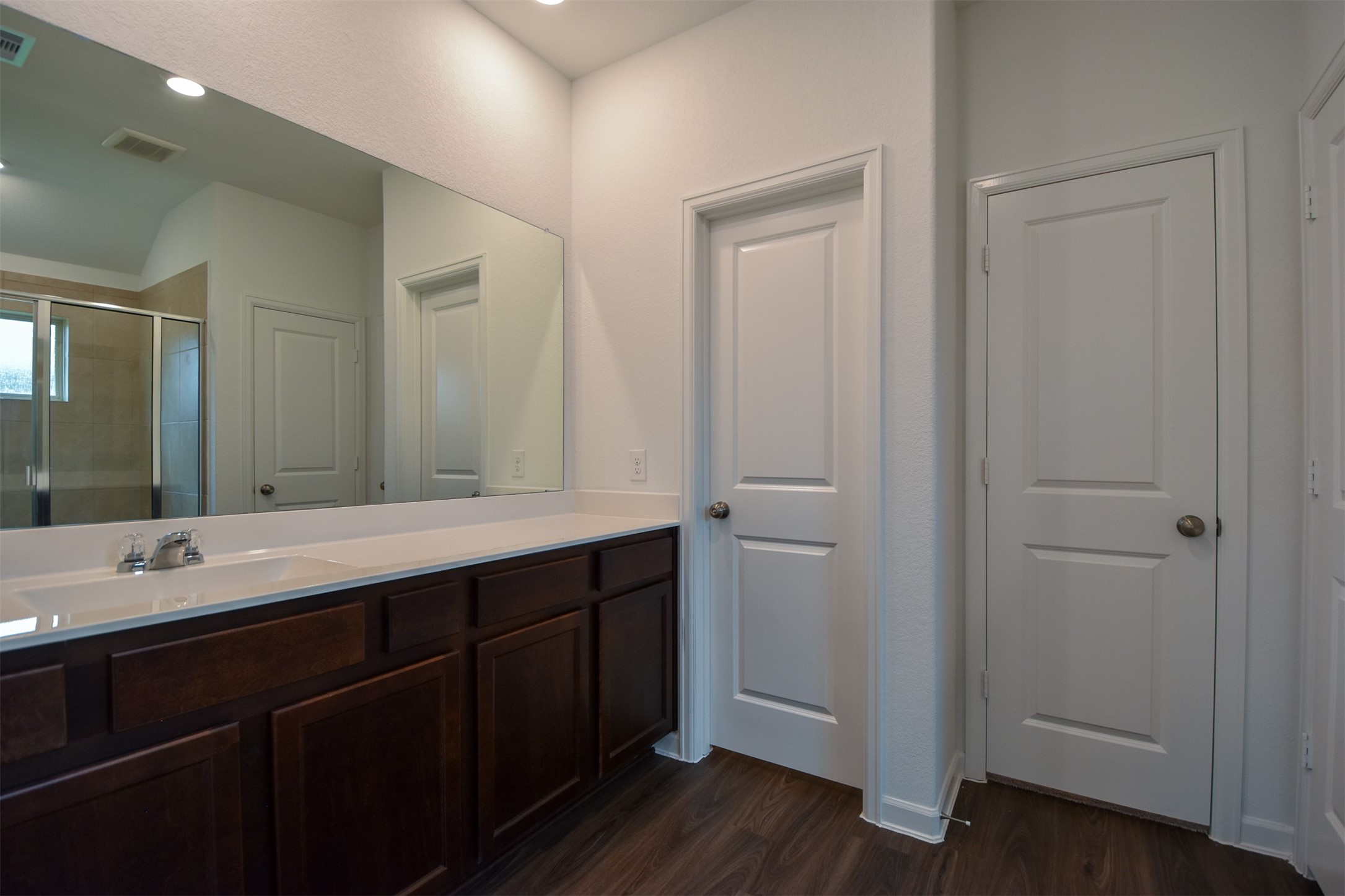 Primary bath with large countertop and plenty of cabinet space