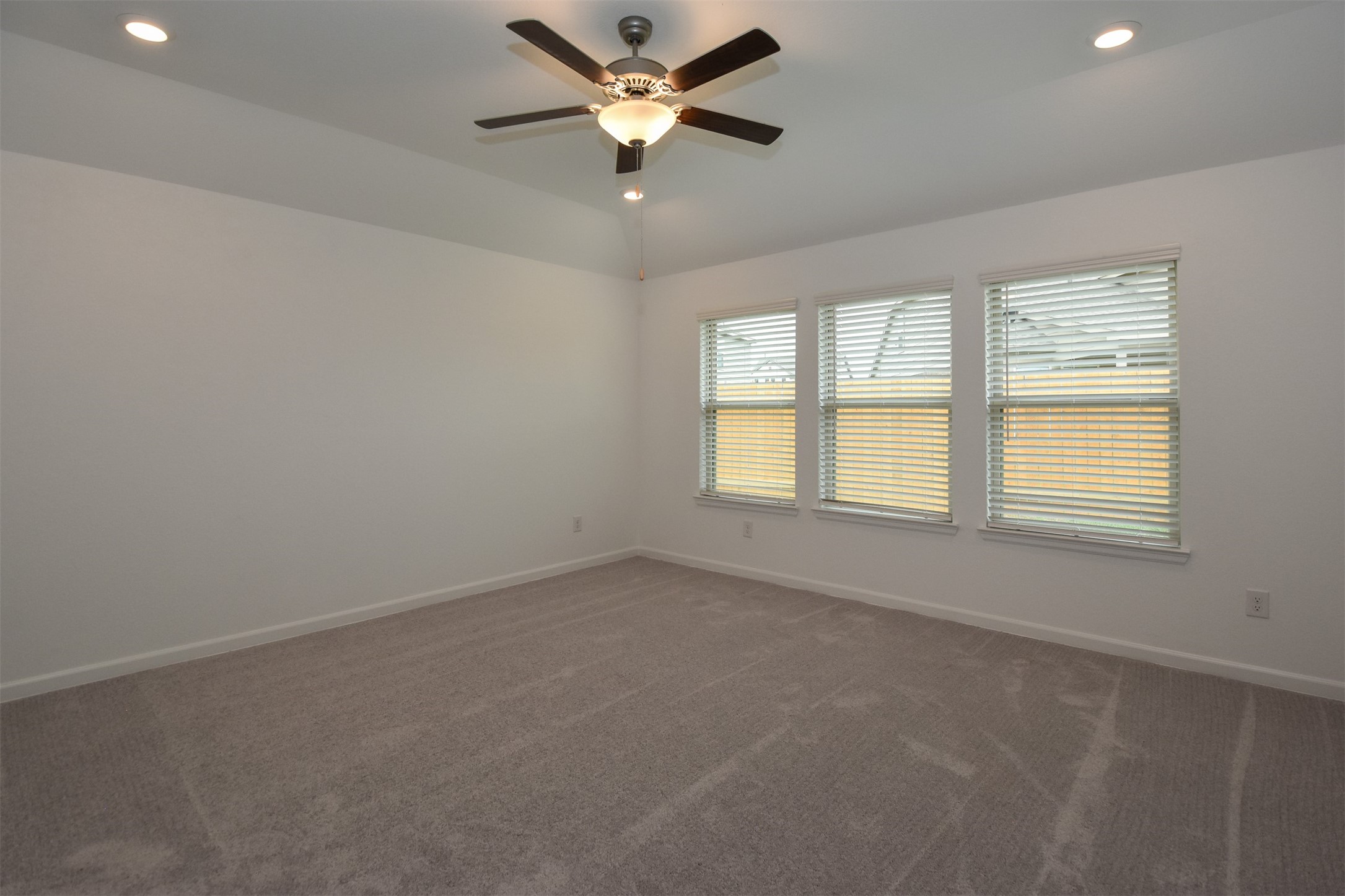 Huge primary bedroom with recess lighting and plenty of windows to keep an eye out on the kids