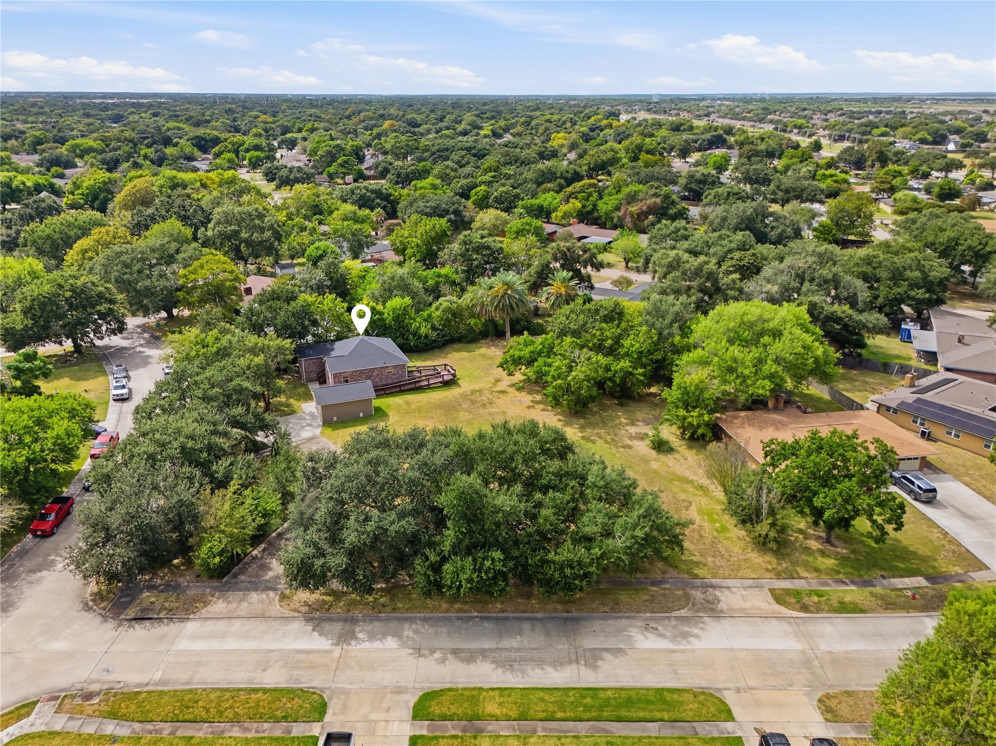 This view shows the homes placement on the lot, with the detached garage, access ramp, and plenty of room for gardening or outdoor activities.