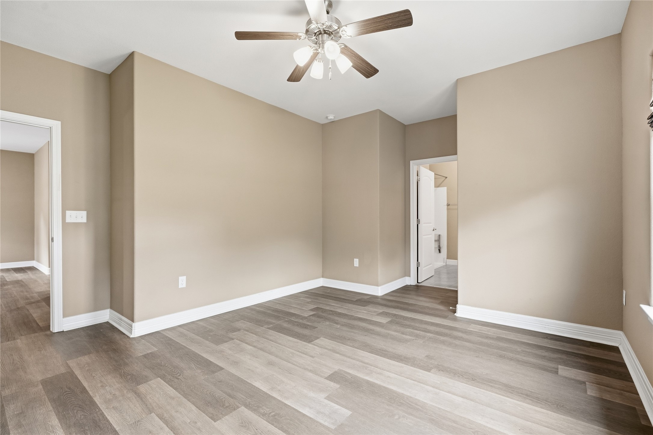 Another view of the primary bedroom shows the wider doorways and direct access to the private bathroom with accessibility features.