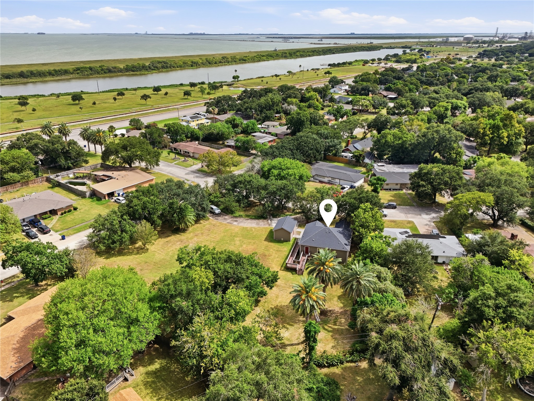 The home sits just a few blocks from the waterfront, with nearby green space and the bay shown in this aerial view.