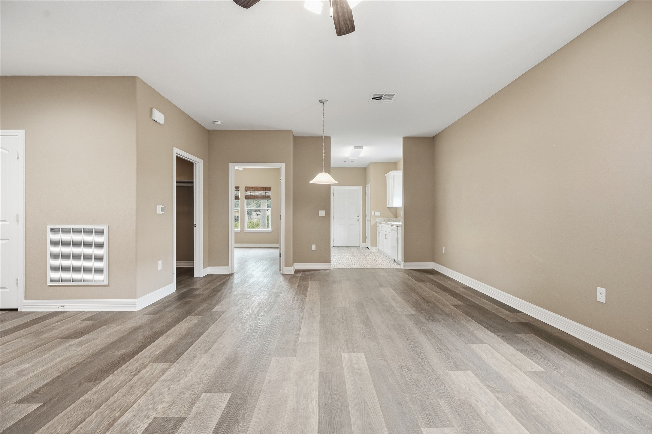 Another view of the living area shows the adjoining dining space just off the kitchen, keeping everyday meals and gatherings close together.