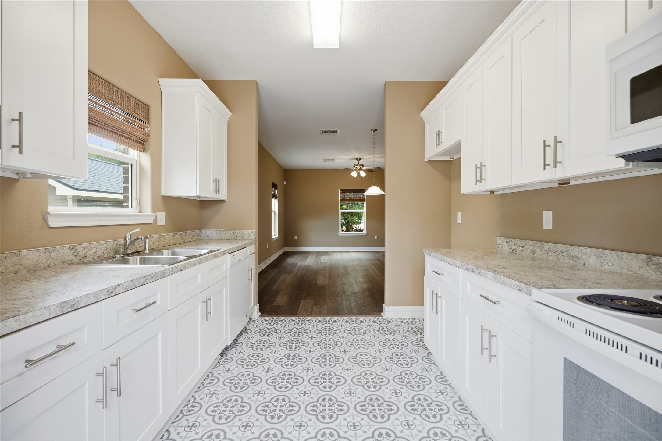 A view from the kitchen into the adjoining dining and living areas, making serving meals and spending time with guests easy.