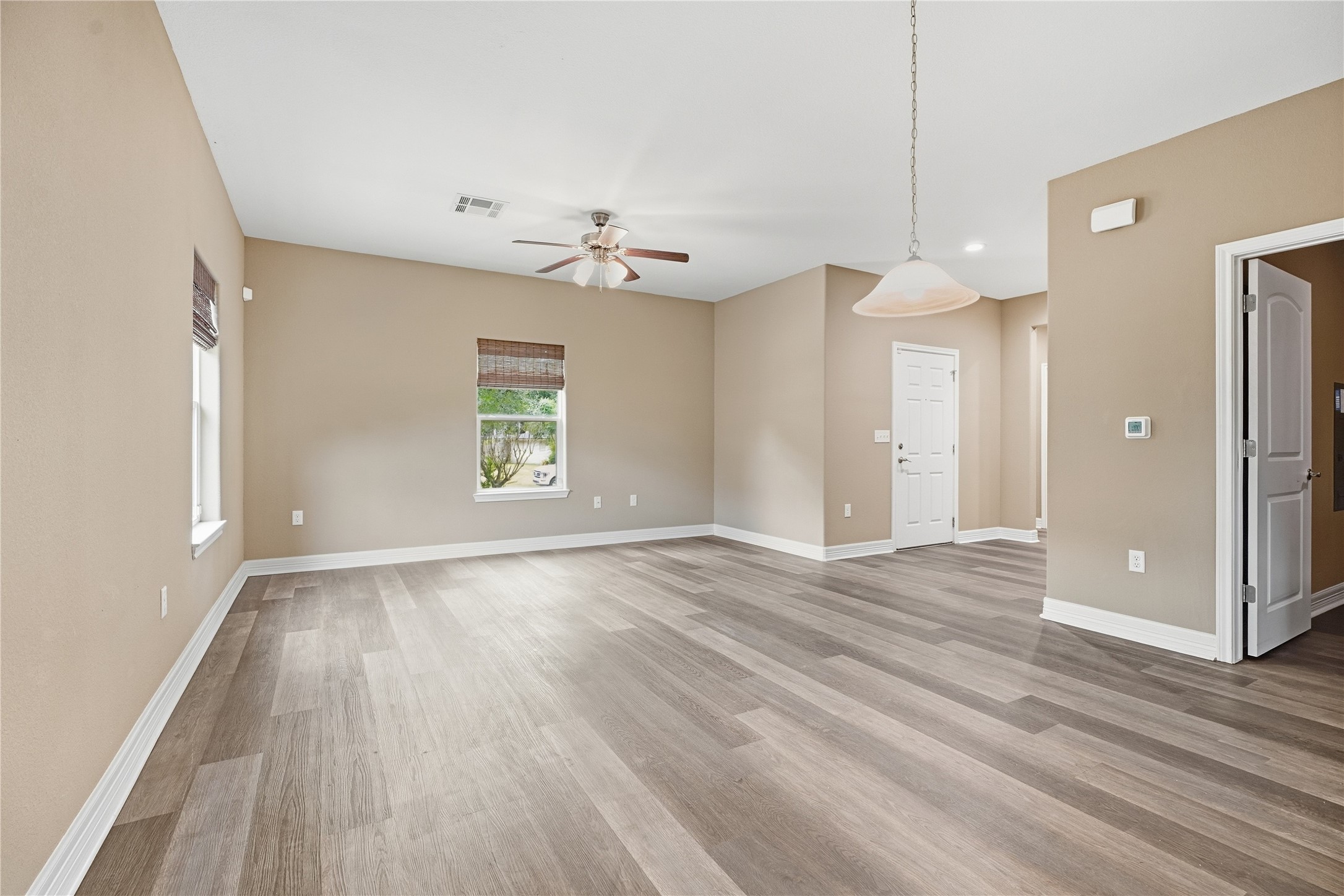 Two windows bring natural light into the living room, which connects to the dining area for an open layout that keeps everyone together.