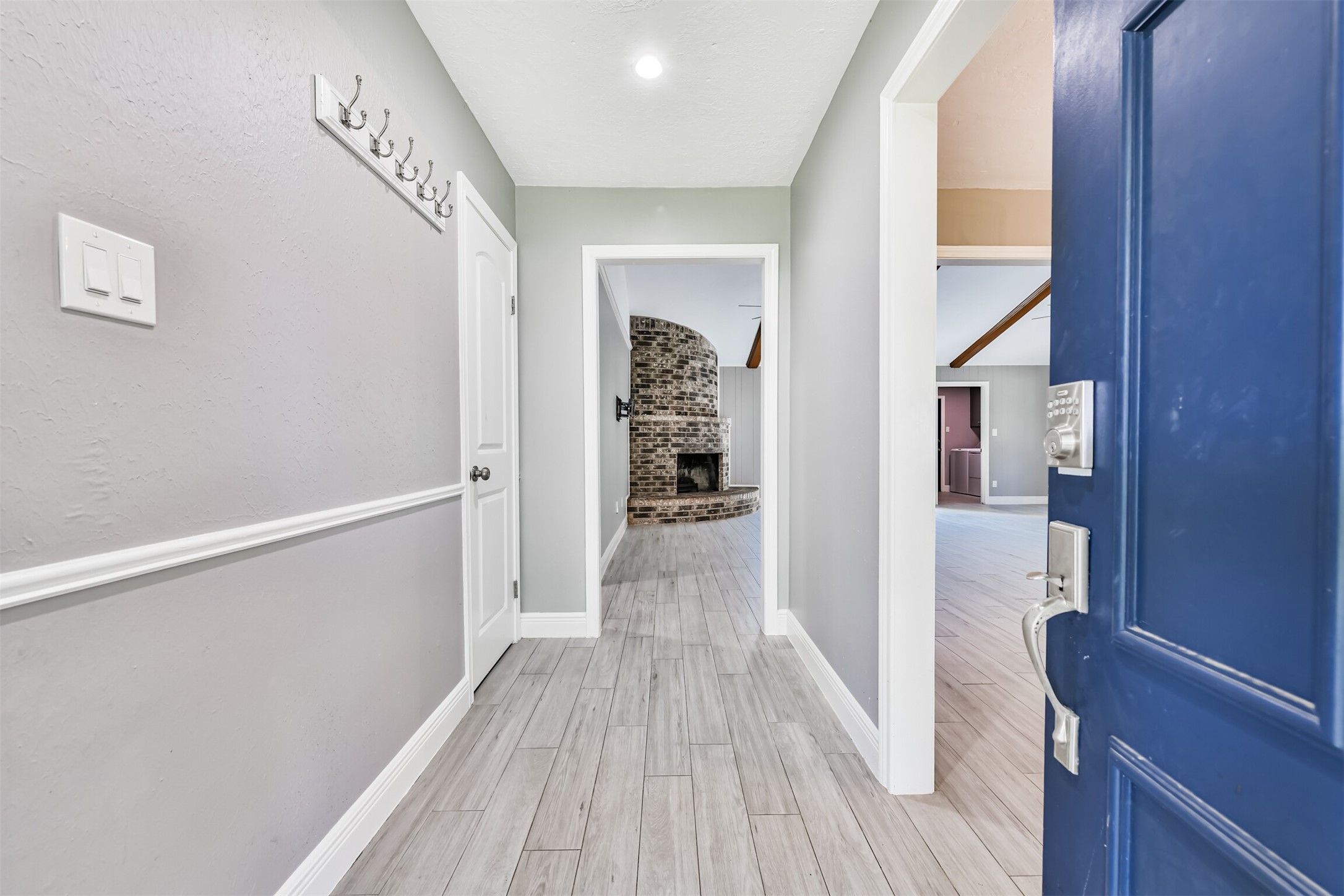 Welcome home to a bright and inviting entryway, featuring sleek tile flooring and modern finishes. This stylish space seamlessly leads you to the heart of the home.