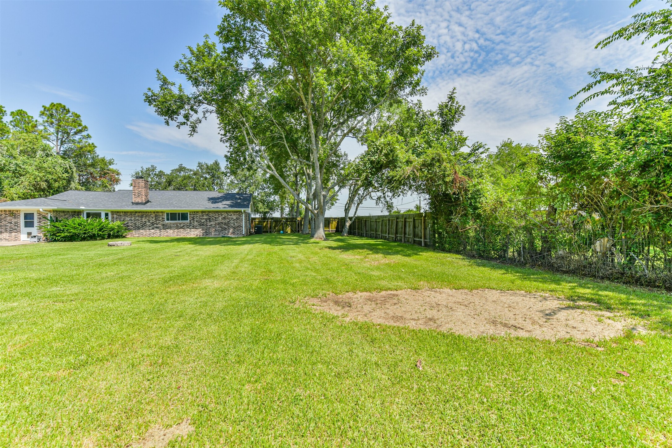 Expansive and serene, this backyard offers lush greenery, perfect for outdoor relaxation and entertainment. Ideal for family gatherings or peaceful retreats.