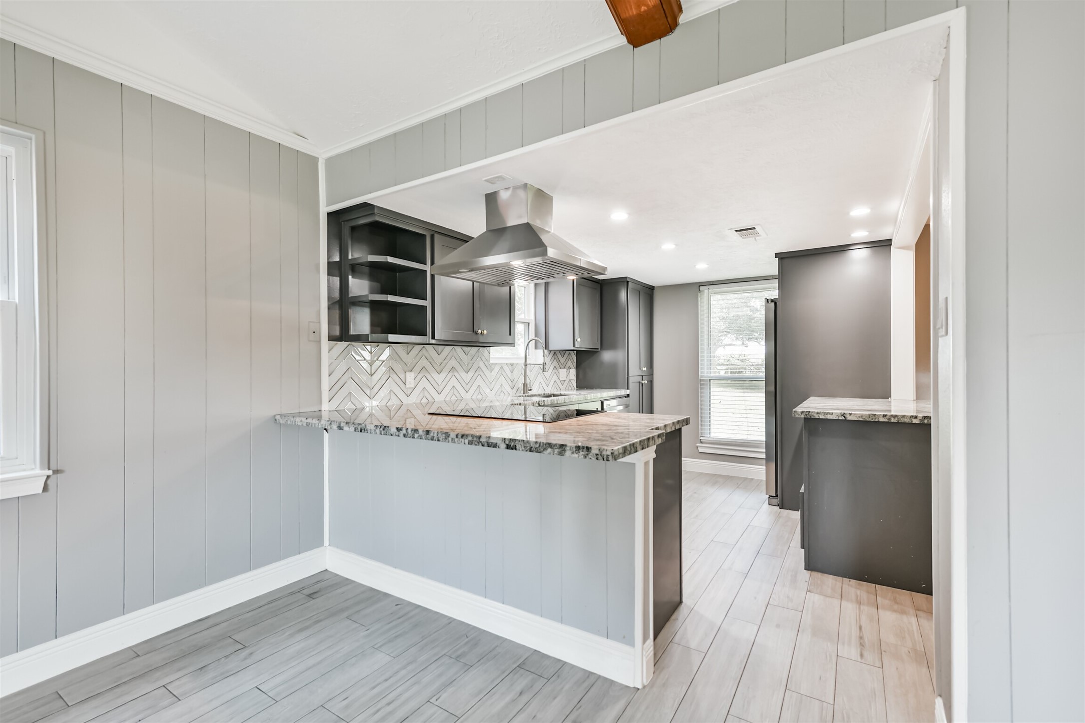This stylish kitchen boasts modern cabinetry, sleek countertops, and a chic backsplash, creating a perfect blend of functionality and elegance.