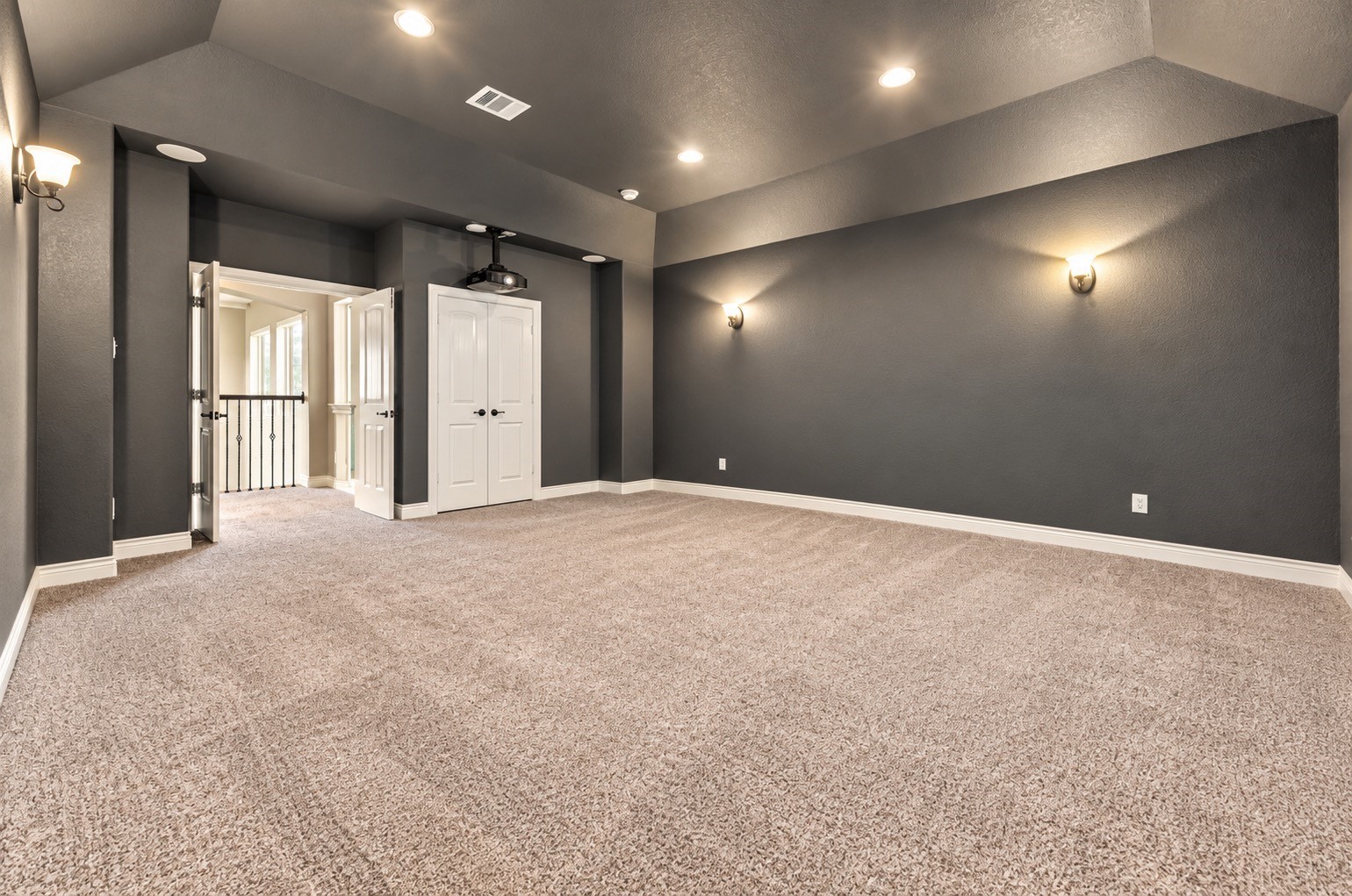 Media room showcasing theater-style seating, large screen and entertainment space.