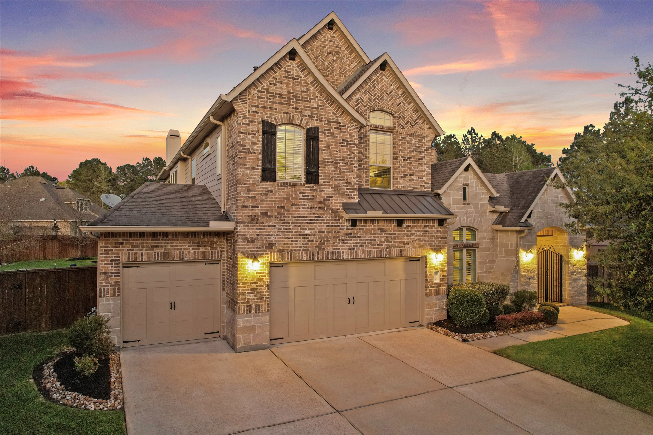 Front exterior showcasing the homes brick faade, landscaping and welcoming curb appeal.