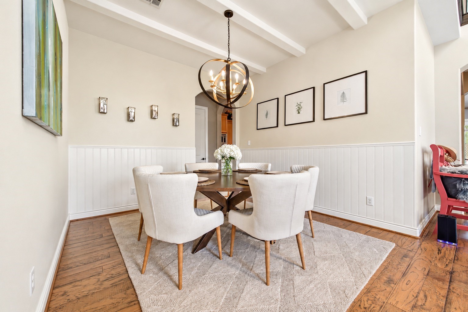 Dining room showcasing the spacious layout, wainscoting and updated neutral finishes. AI-generated image depicting a potential wall paint color.AI-generated image depicting a potential wall paint color.