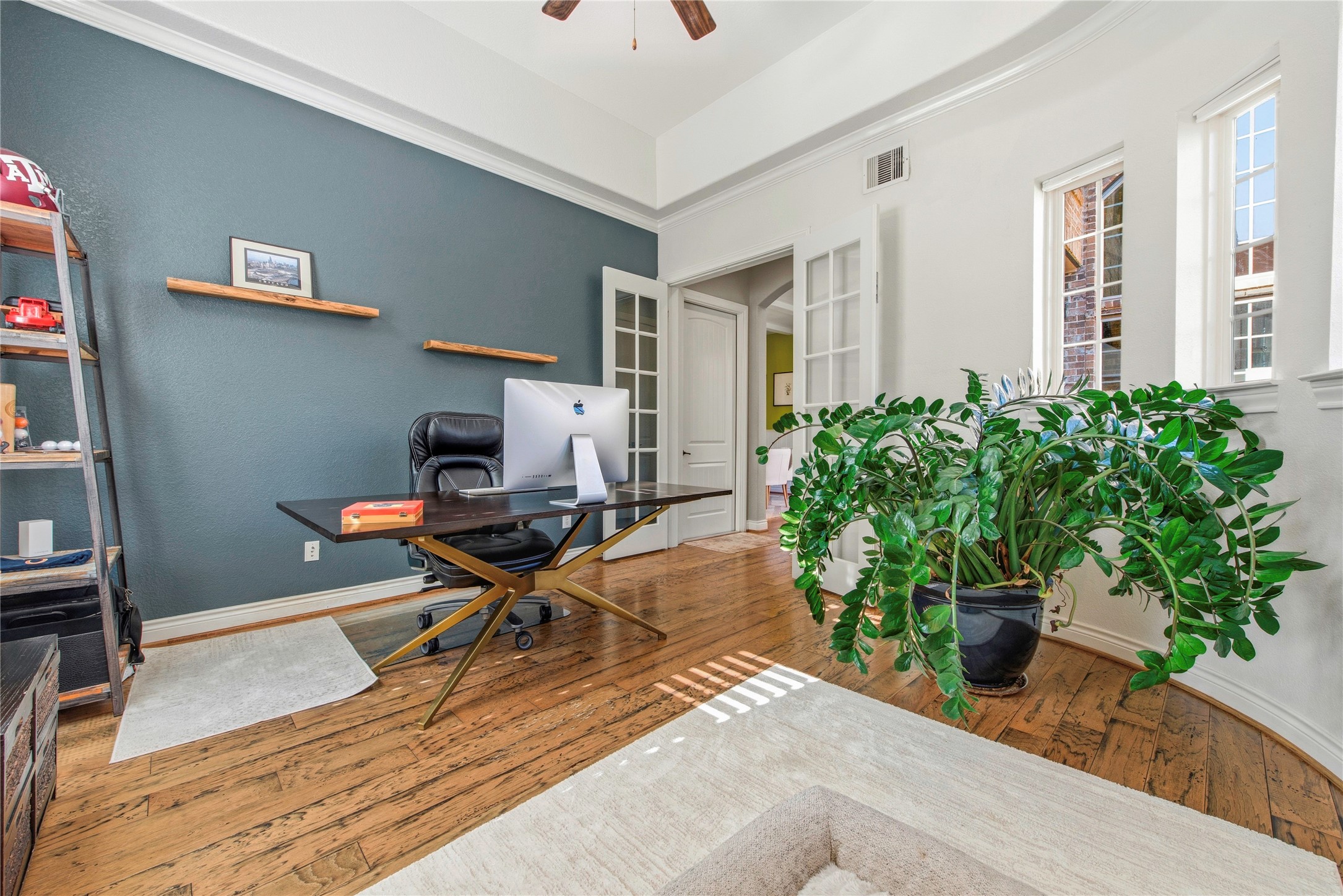 Spacious living area featuring hardwood floors, abundant natural light and comfortable seating.