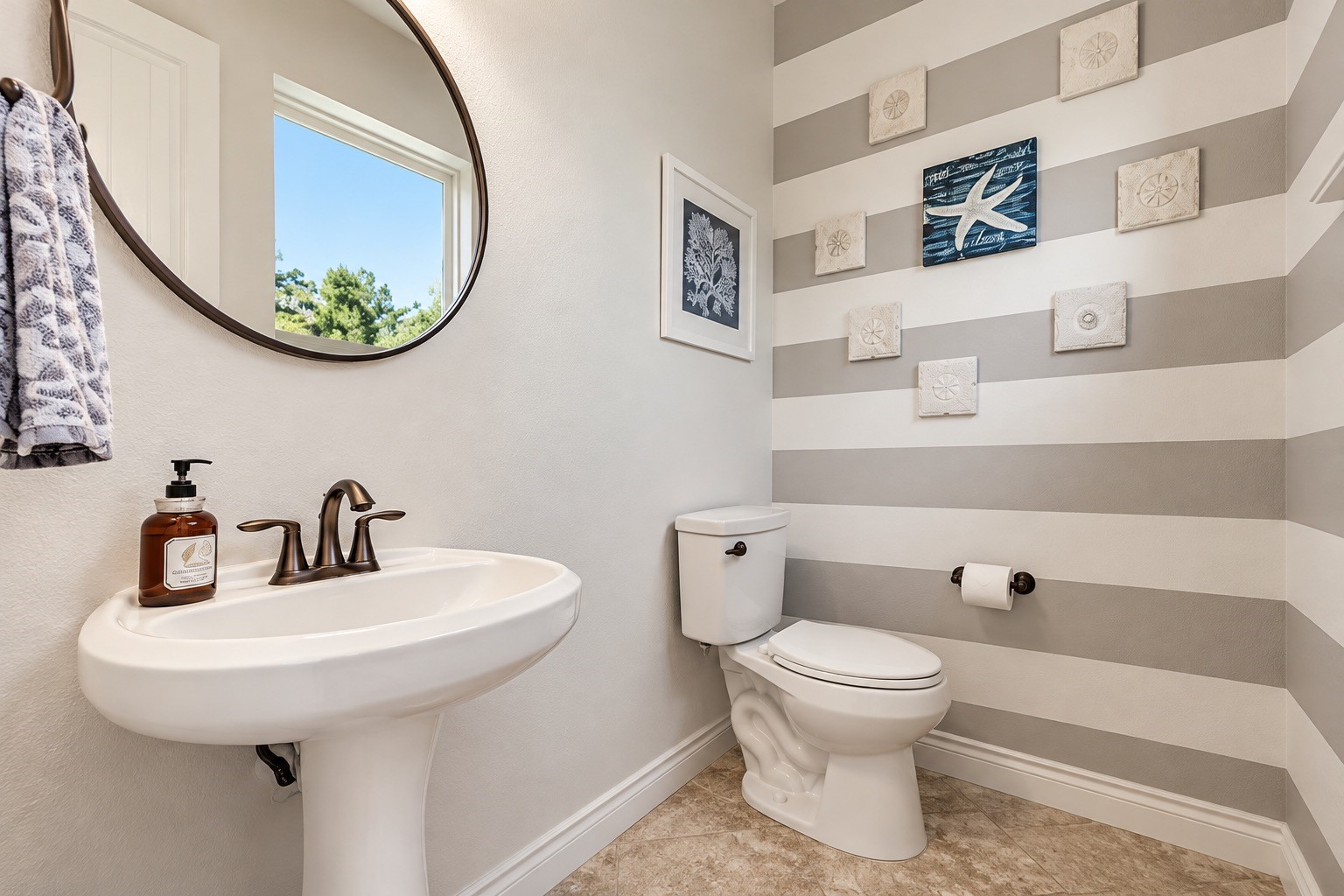 Stylish bathroom featuring a modern vanity, decorative tile and abundant natural light.
