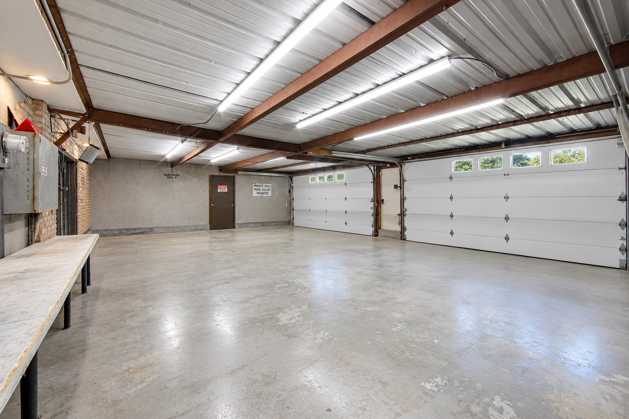 Rear of Main Garage has 2 Roll up doors & extra work space