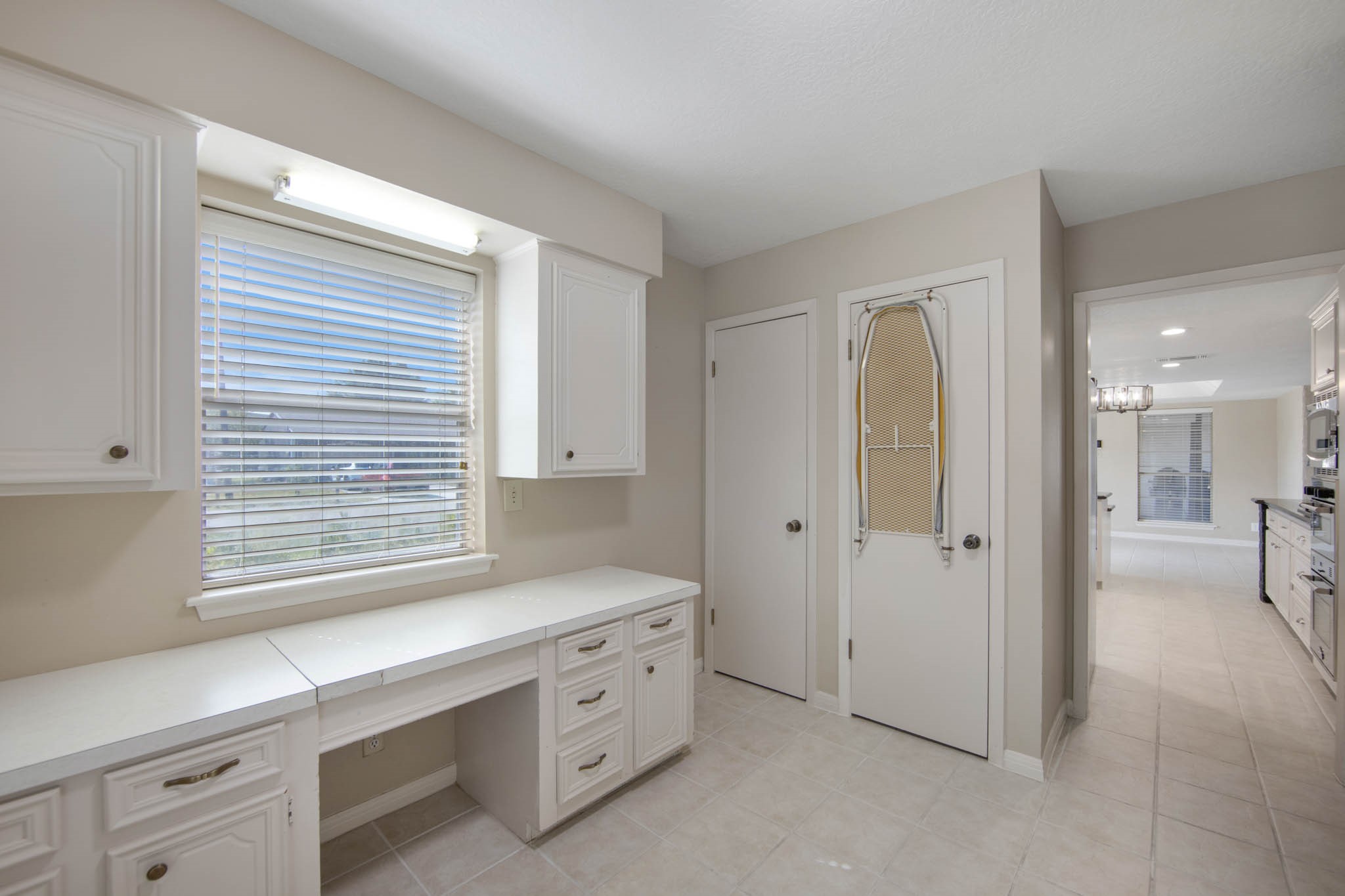 Large workspace in the laundry room that can be used for another office