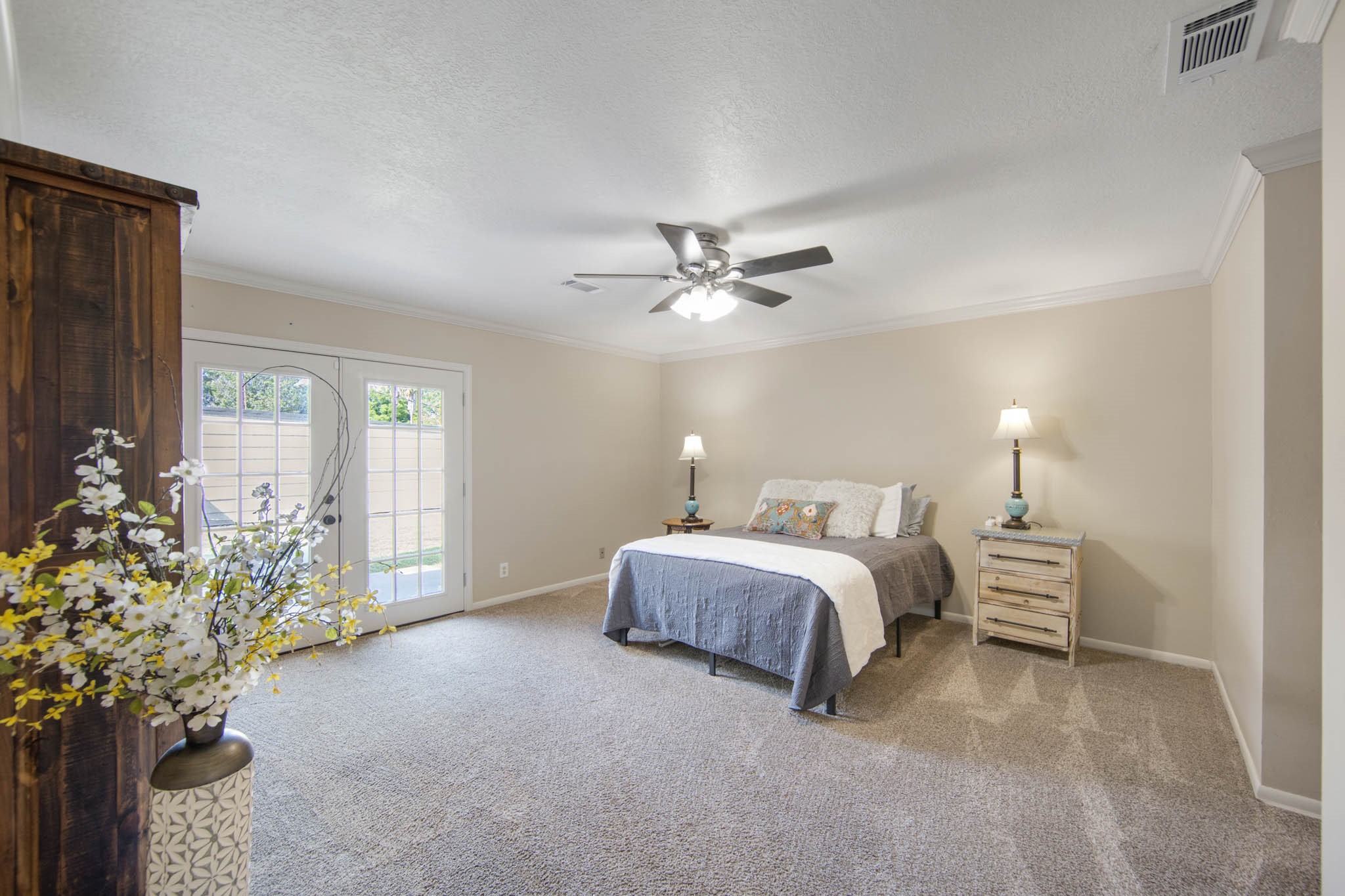 Large Master Bedroom with French doors leading to the patio