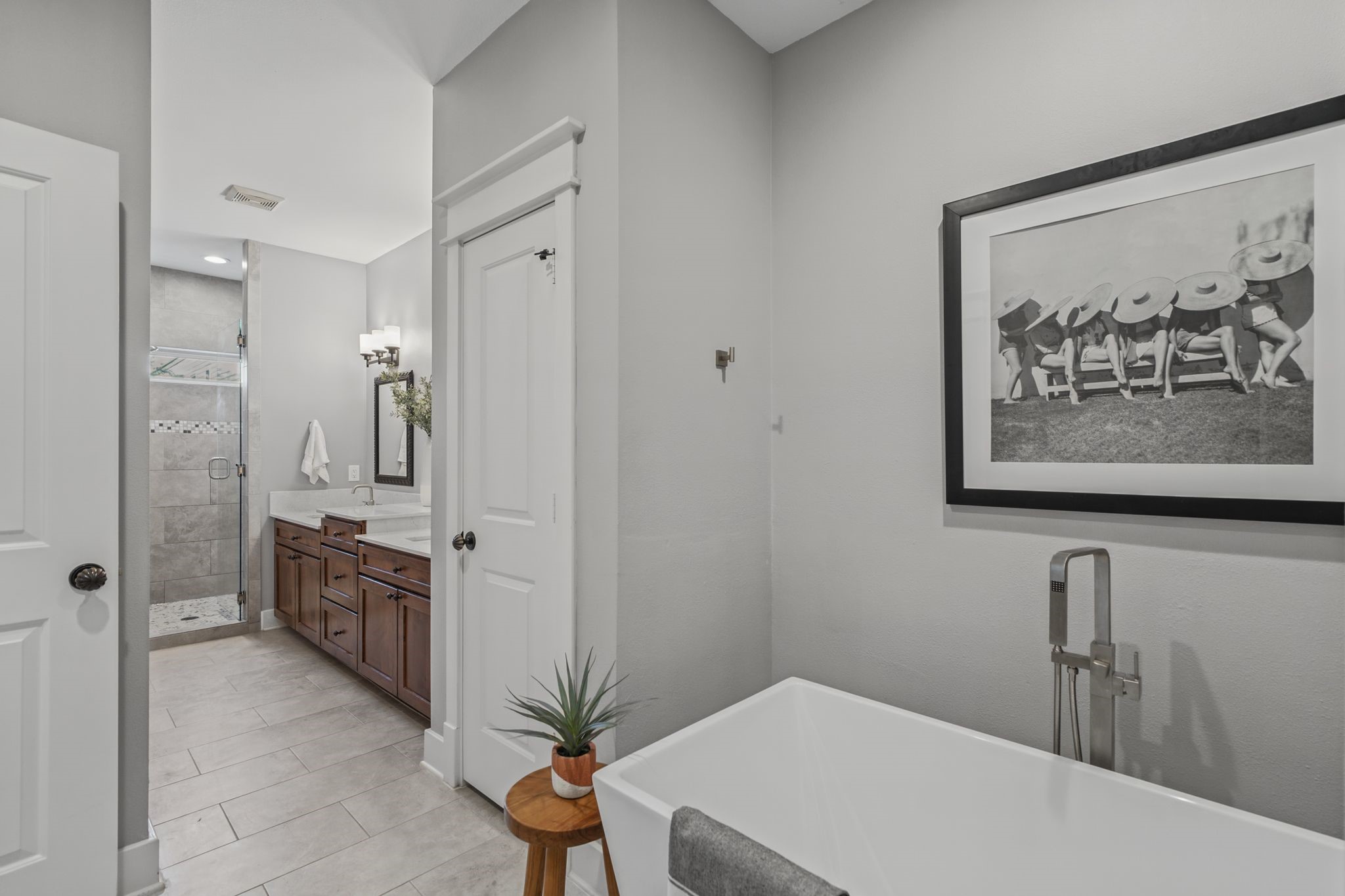 The beautifully renovated primary bathroom features a soaking tub and separate walk-in shower.